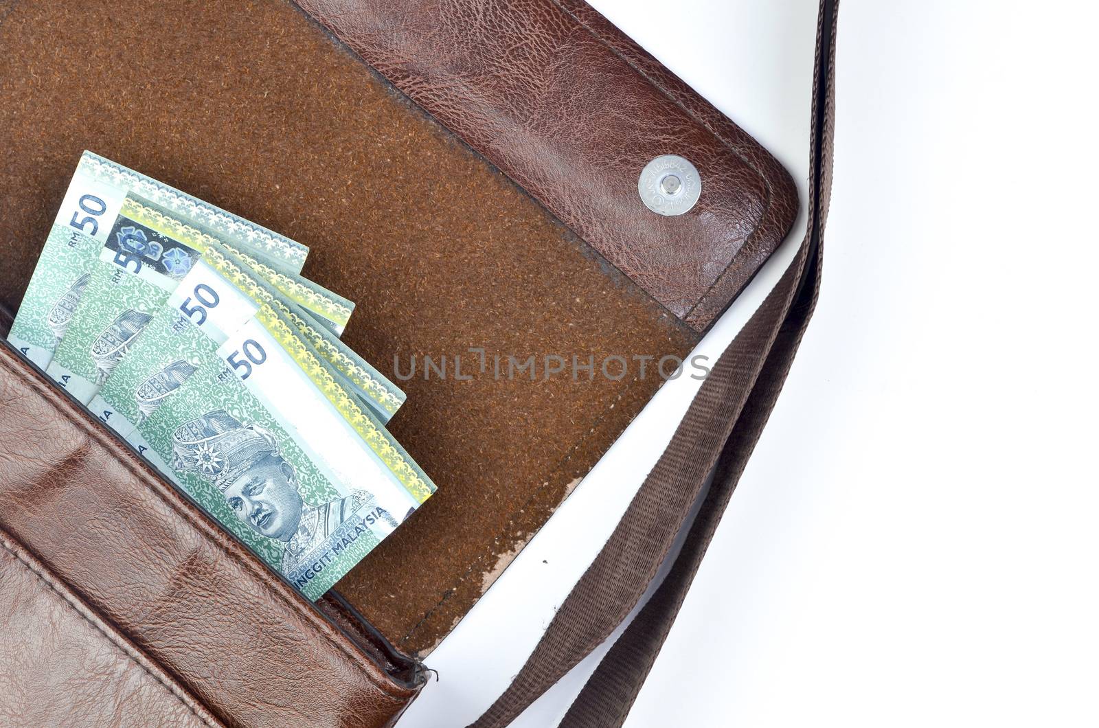 Malaysia bank note with sling bag on white background.