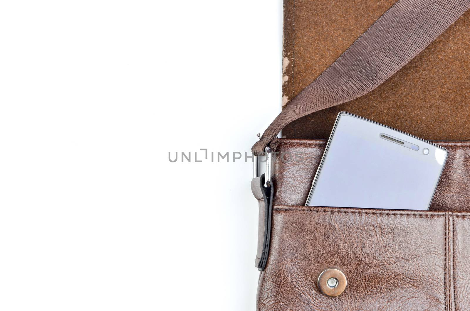 Leather sling bag with smartphone on white background.