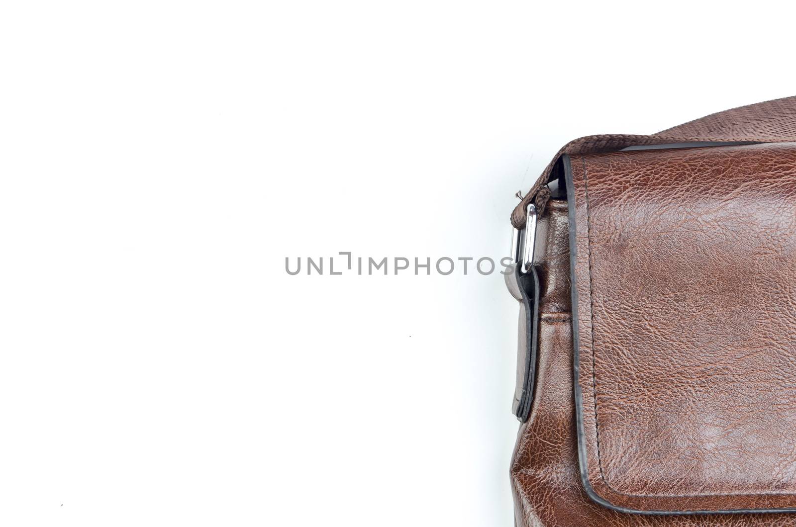 Brown sling bag on white background. Selective focus.