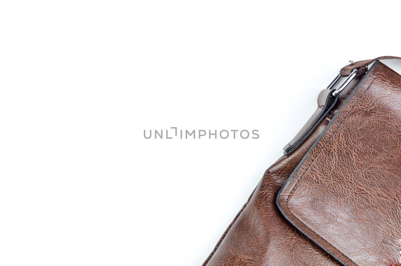 Brown sling bag on white background. Selective focus.