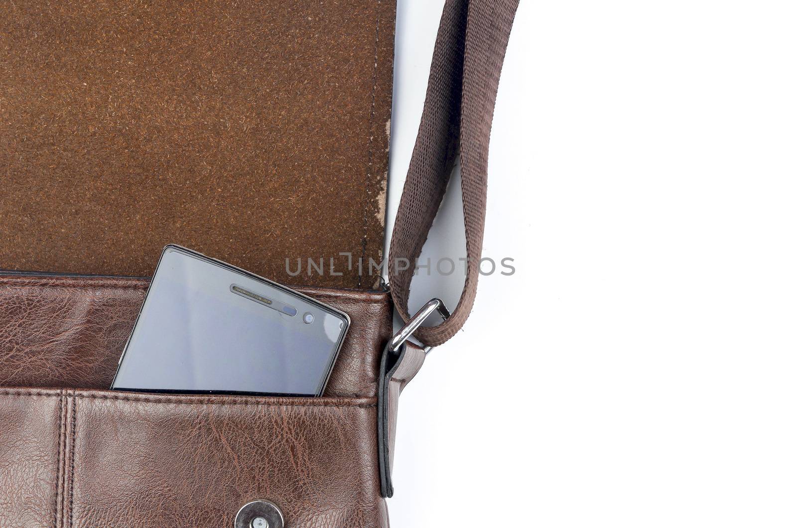 Leather sling bag with smartphone on white background.