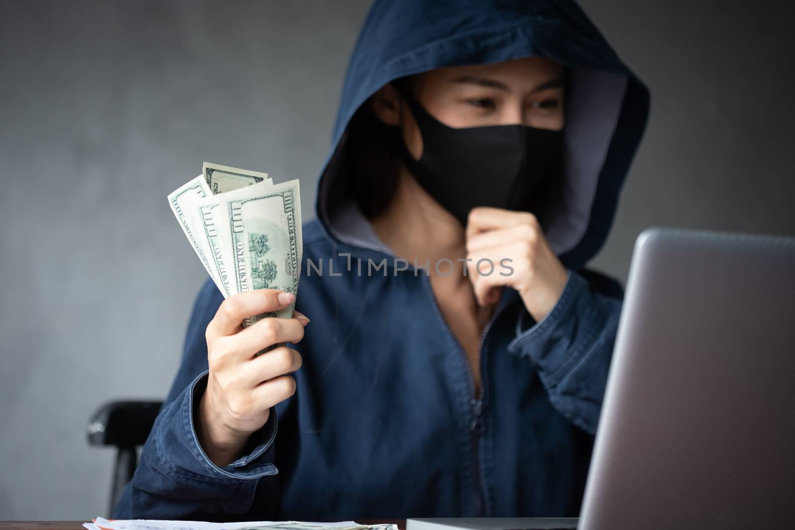 Professional hacker women Wearing a blue shirt with a hood Steal by photosam