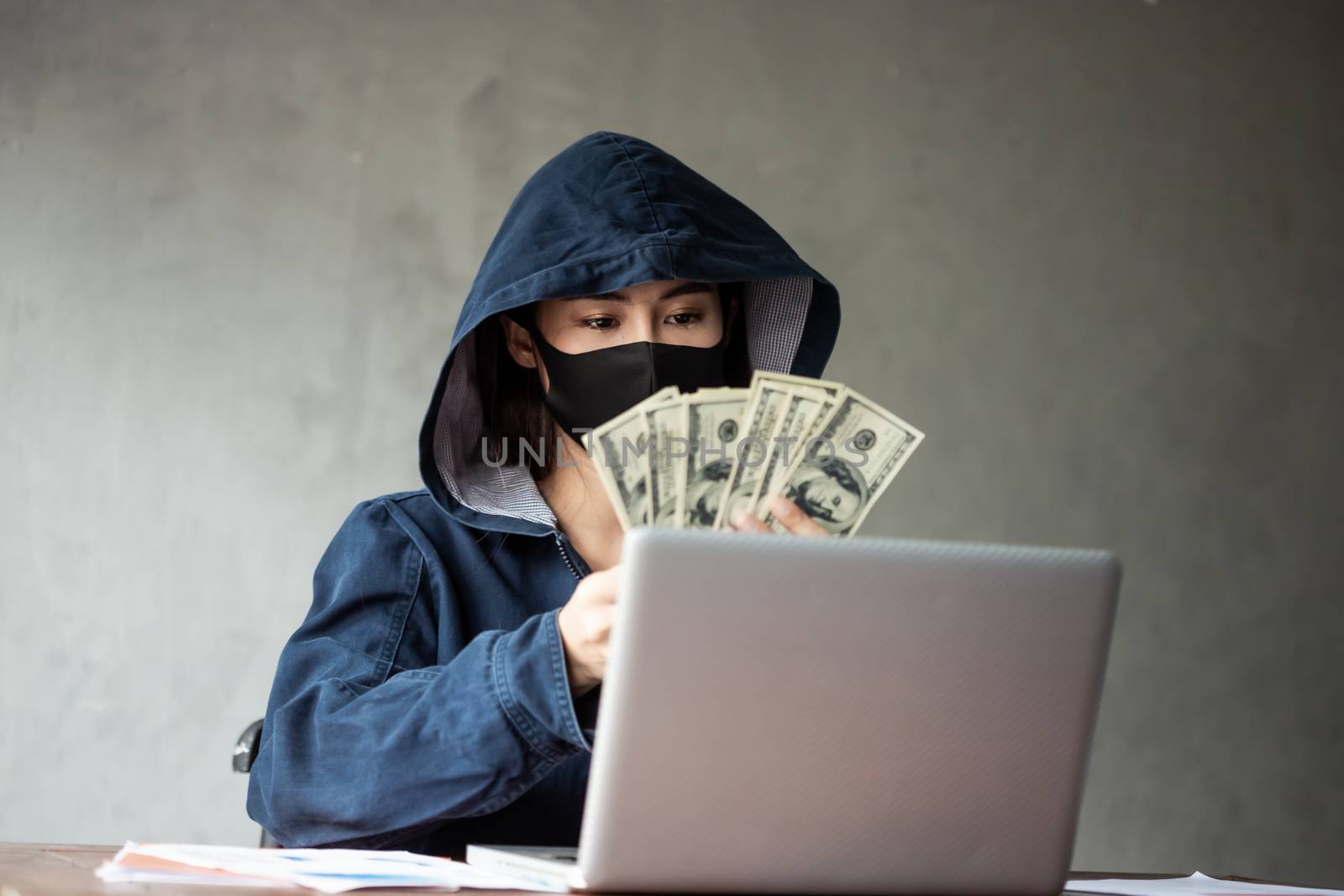 Professional hacker women Wearing a blue shirt with a hood Steal by photosam
