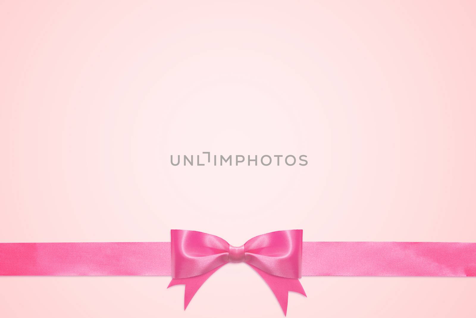 vintage greeting card template decorative with pink bow with horizontal ribbon isolated on pink background with copy space by asiandelight