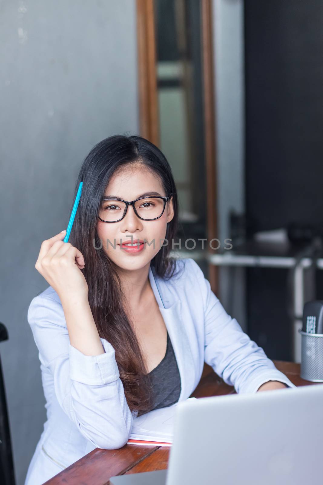 Business women wear glasses Beautiful asians Have fun in the off by photosam