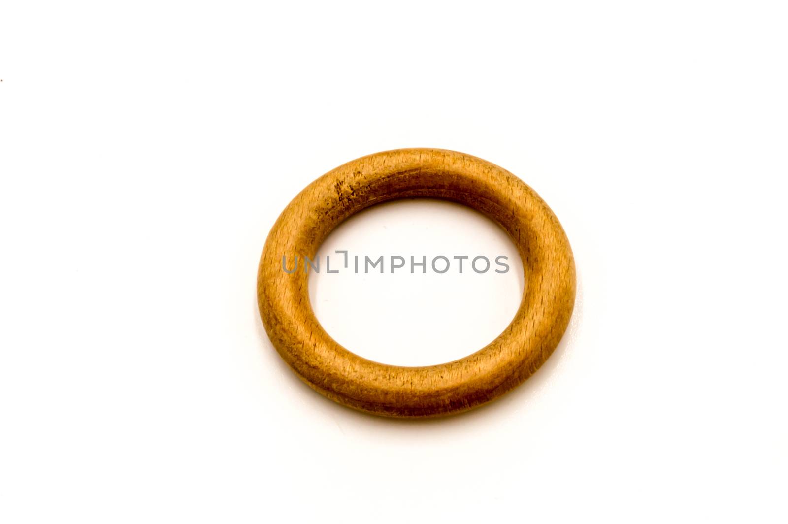 light colored wooden ring on a white background
