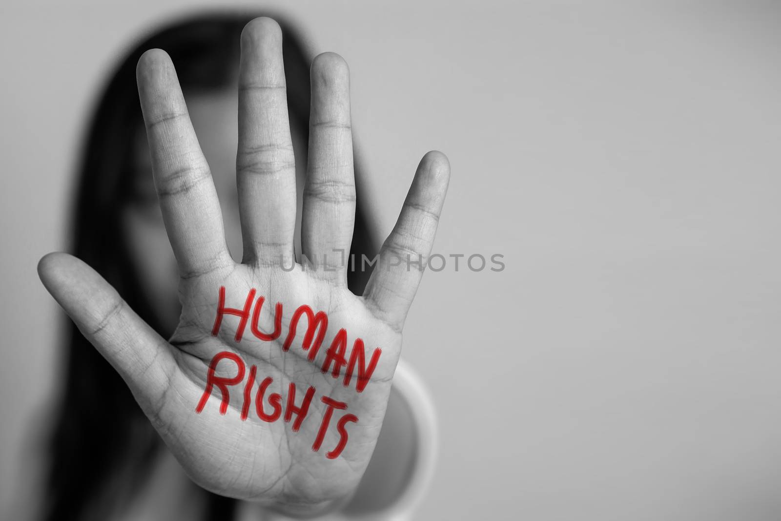 human rights concept. woman raised her hand for dissuade, hand write the word human rights in red color. by asiandelight
