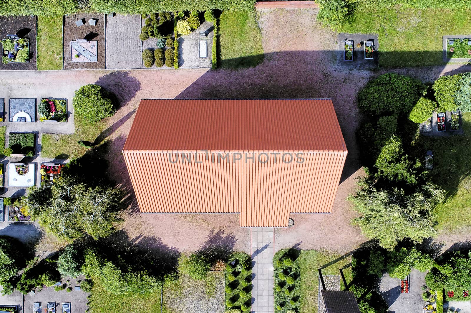 Aerial picture of a chapel on the cemetery near a village by geogif