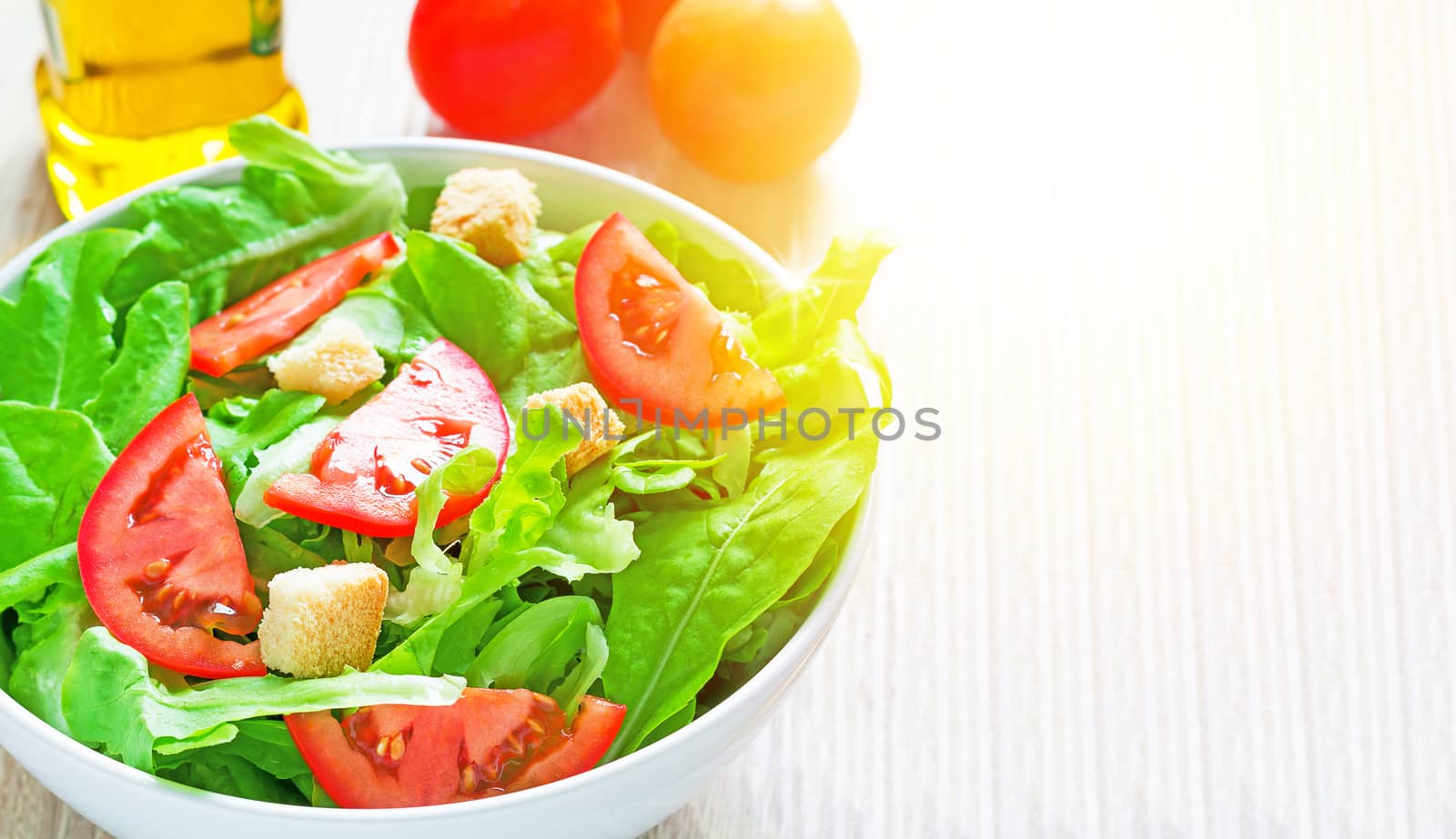 Fresh salad on wood table with sunlight, diet food concept