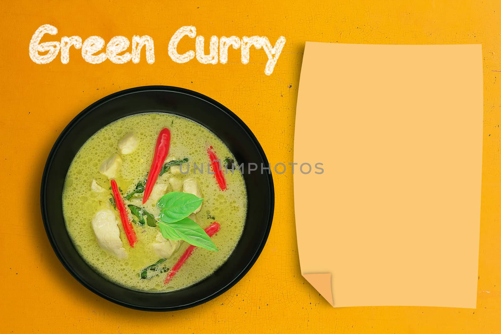 Green curry chicken on yellow background, copy space