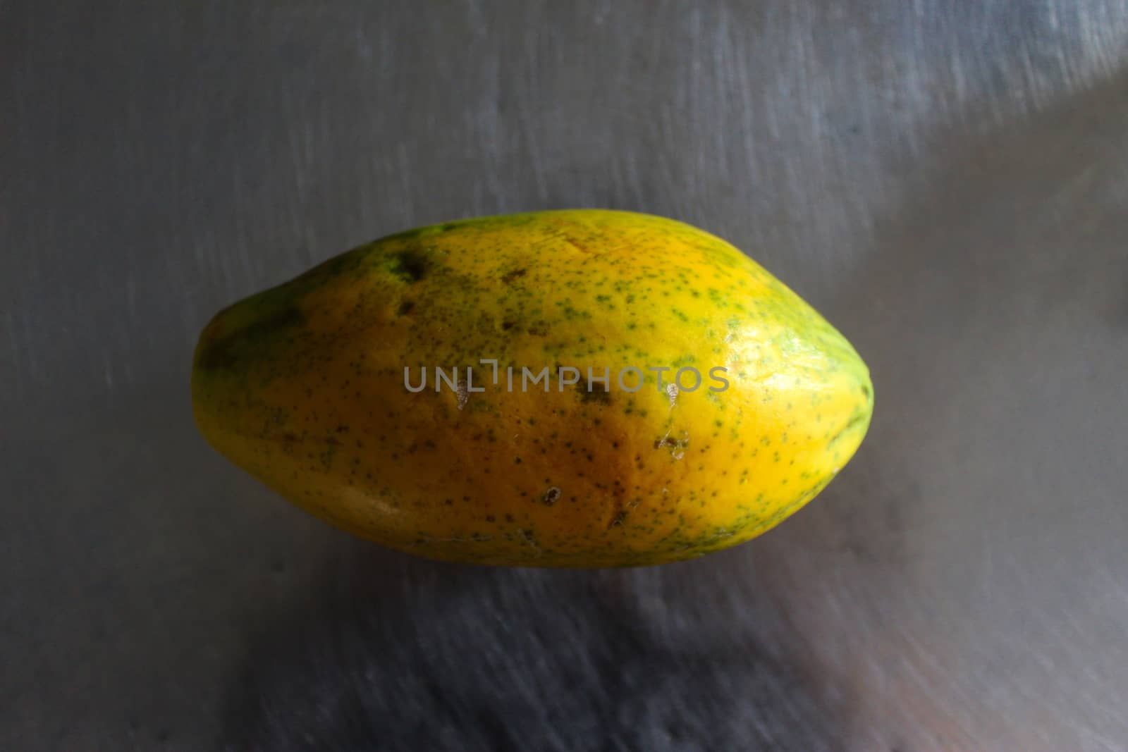 Papaya fruit on the kitchen table. by mahirrov
