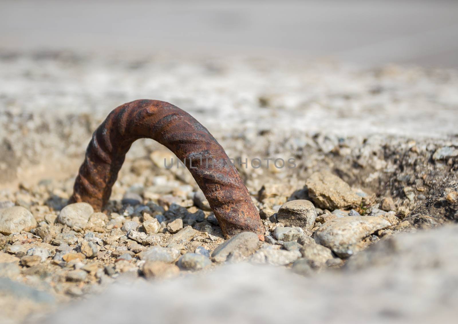 Extreme close up of concrete weight. Defocused blurry background.