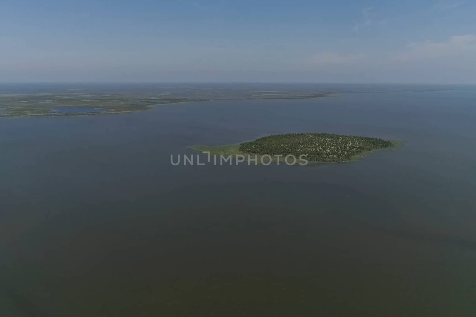 View from above on the coastal forest tundra. River and islands with taiga.