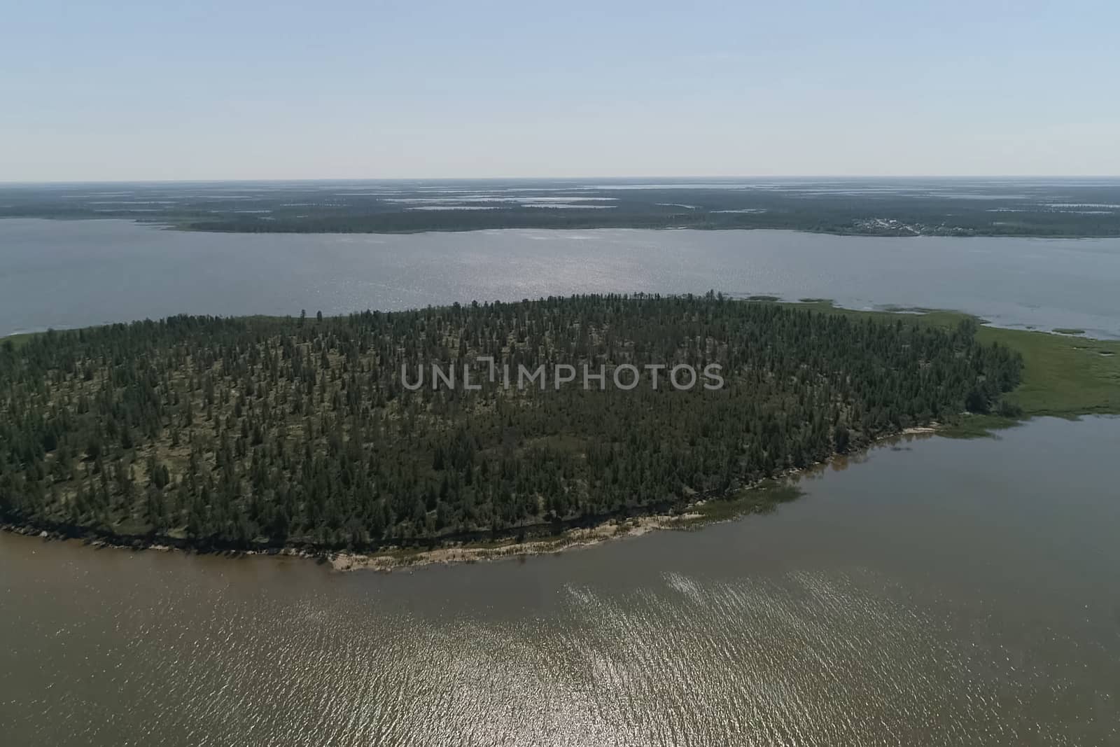 View from above on the coastal forest tundra. River and islands with taiga.