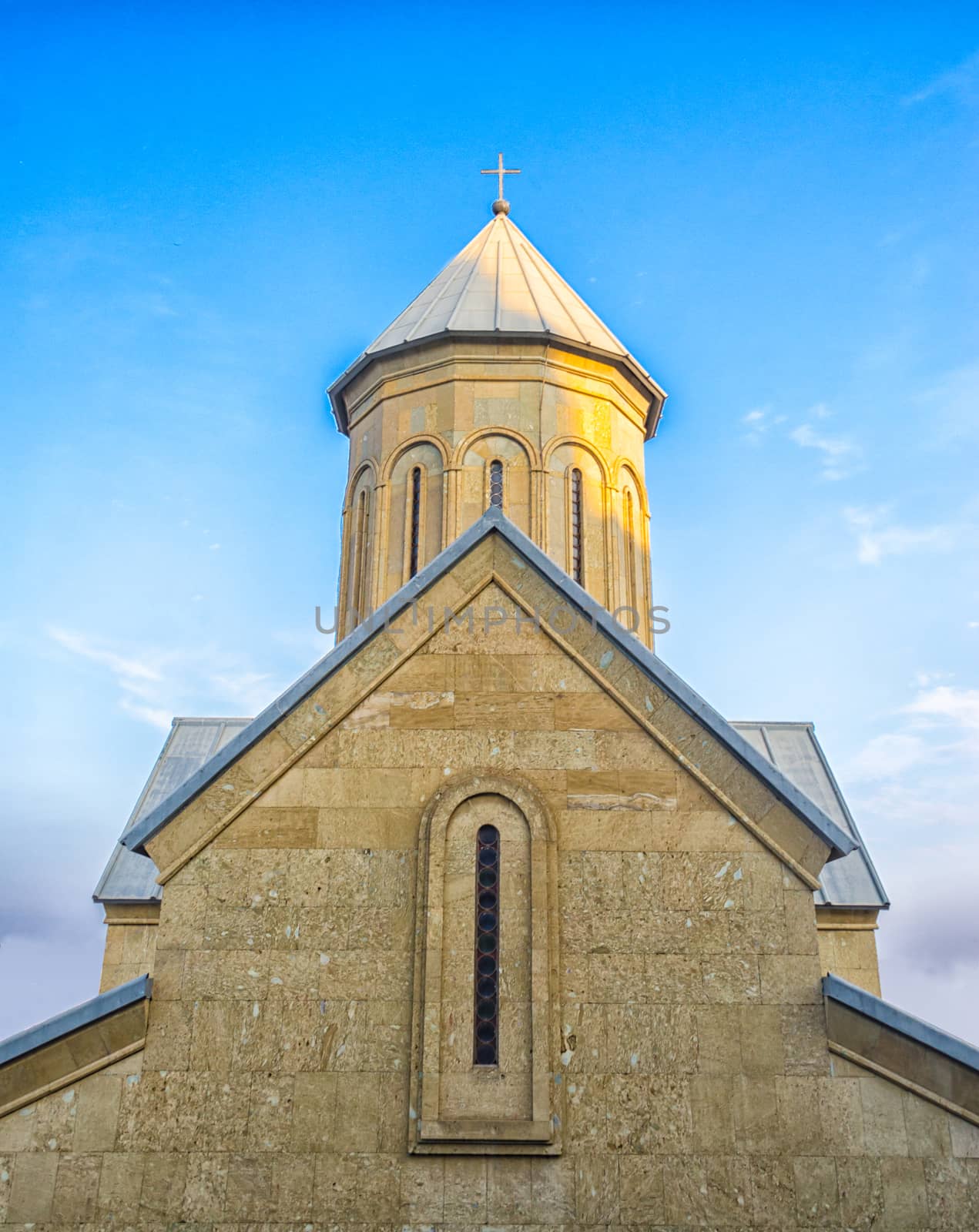 Temple of the Georgian Orthodox Church on a background of blue sky with clouds