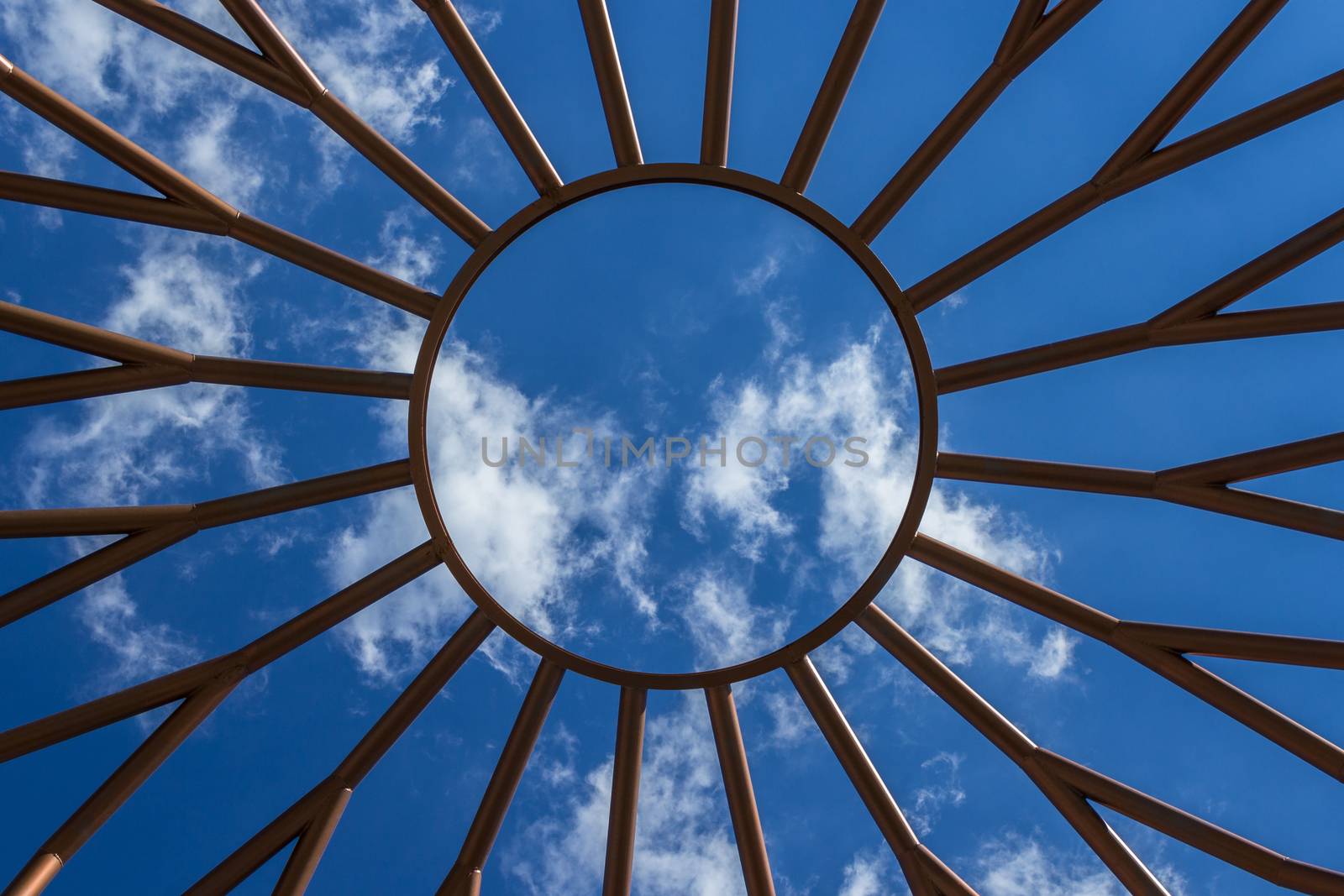 Bottom view of an iron structure, with blue sky in the background.