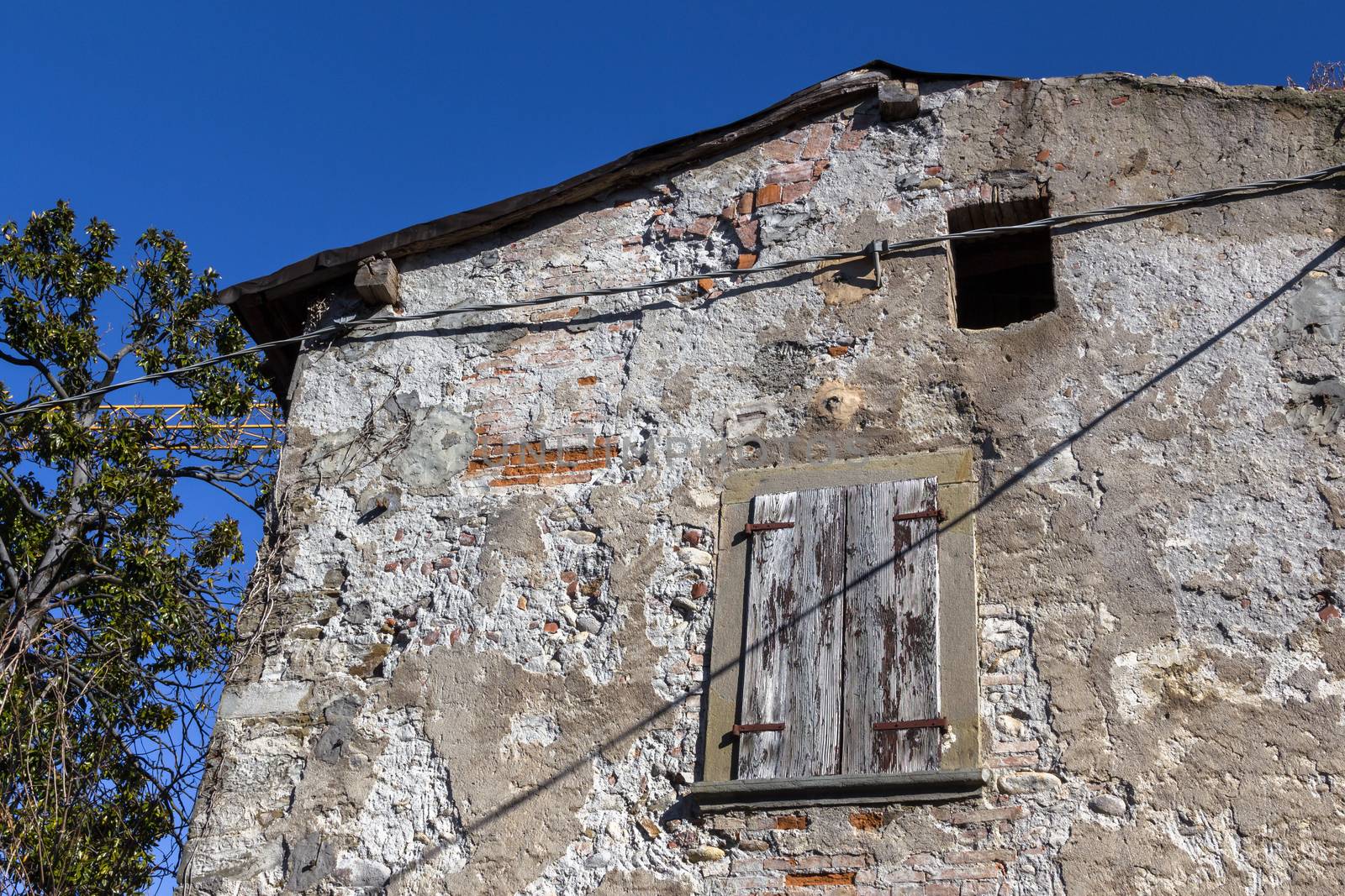 Big old abandoned house with rotten windows, to renovation.