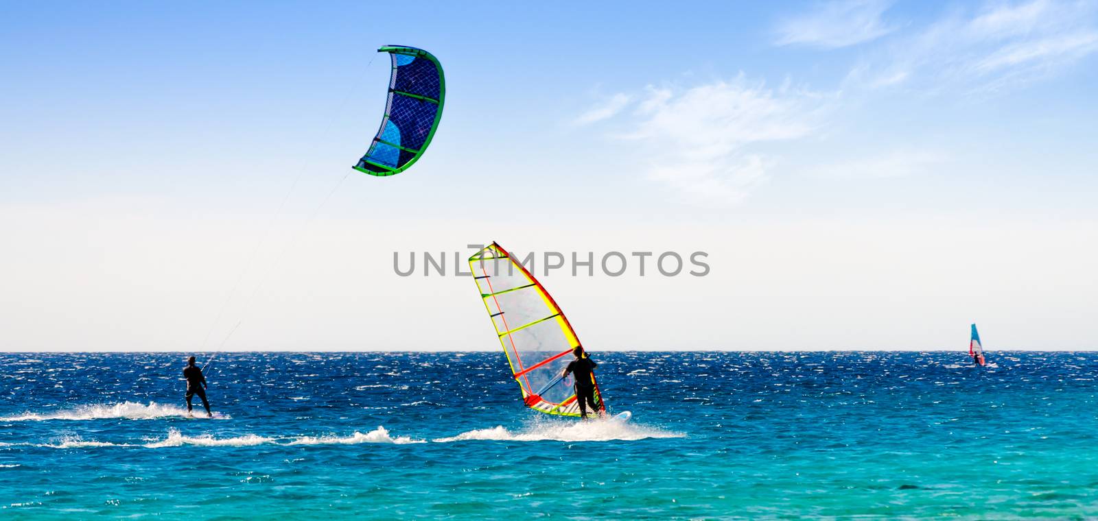 windsurfers and kitesurfers ride in the Red Sea in Sharm El Sheikh