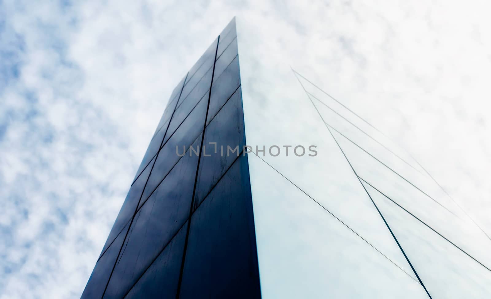 wall of a modern building against the sky and clouds abstract architectural background