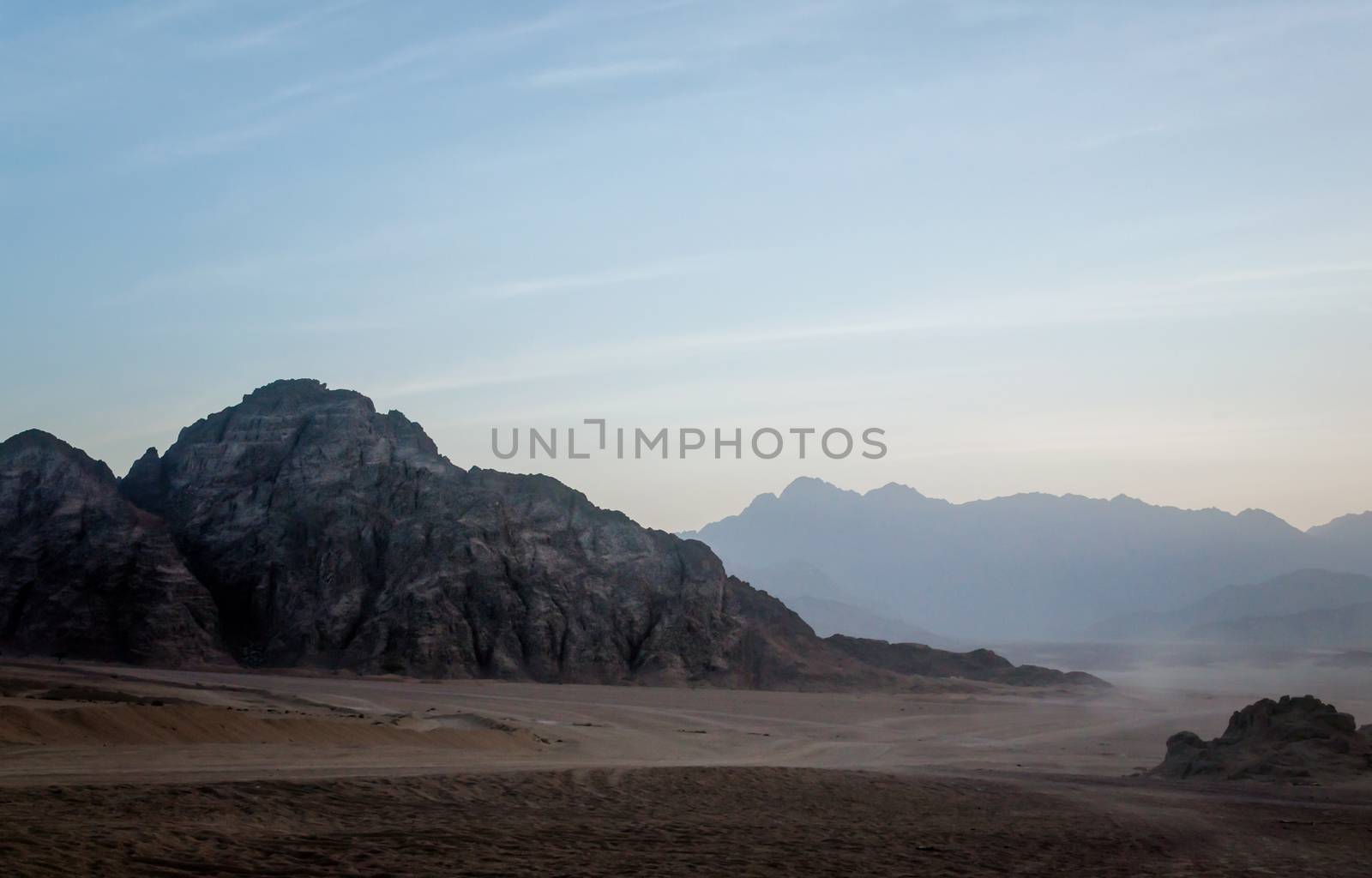 night desert landscape with rocky mountains and sunset sky with clouds in Sharm El Sheikh Egypt