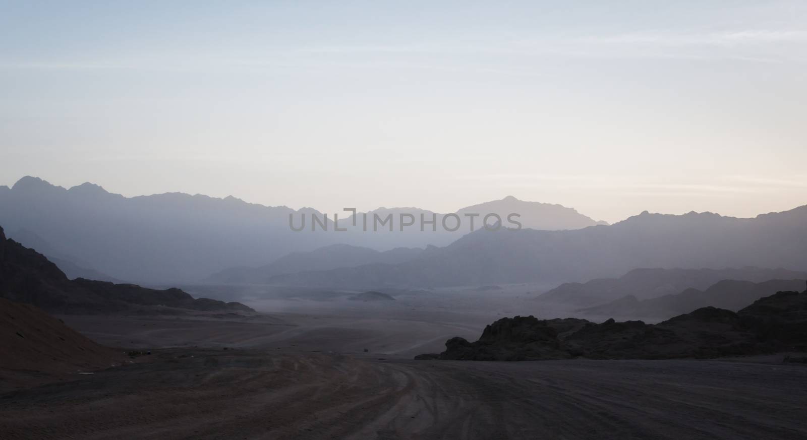 night desert landscape with rocky mountains and sunset sky with clouds in Sharm El Sheikh Egypt