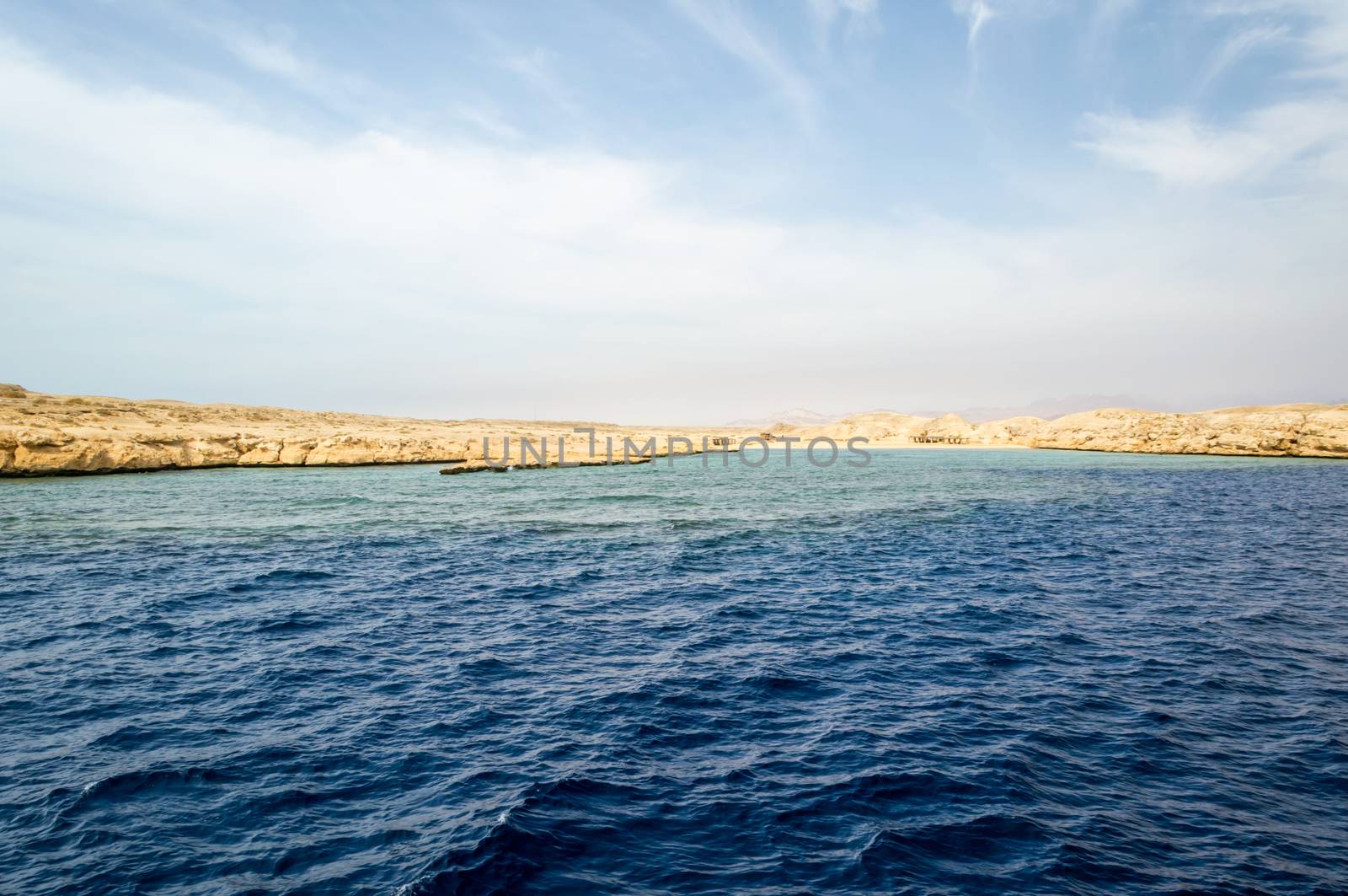 landscape rocky coast of the Red Sea and blue sky with clouds in Sharm El Sheikh Egypt