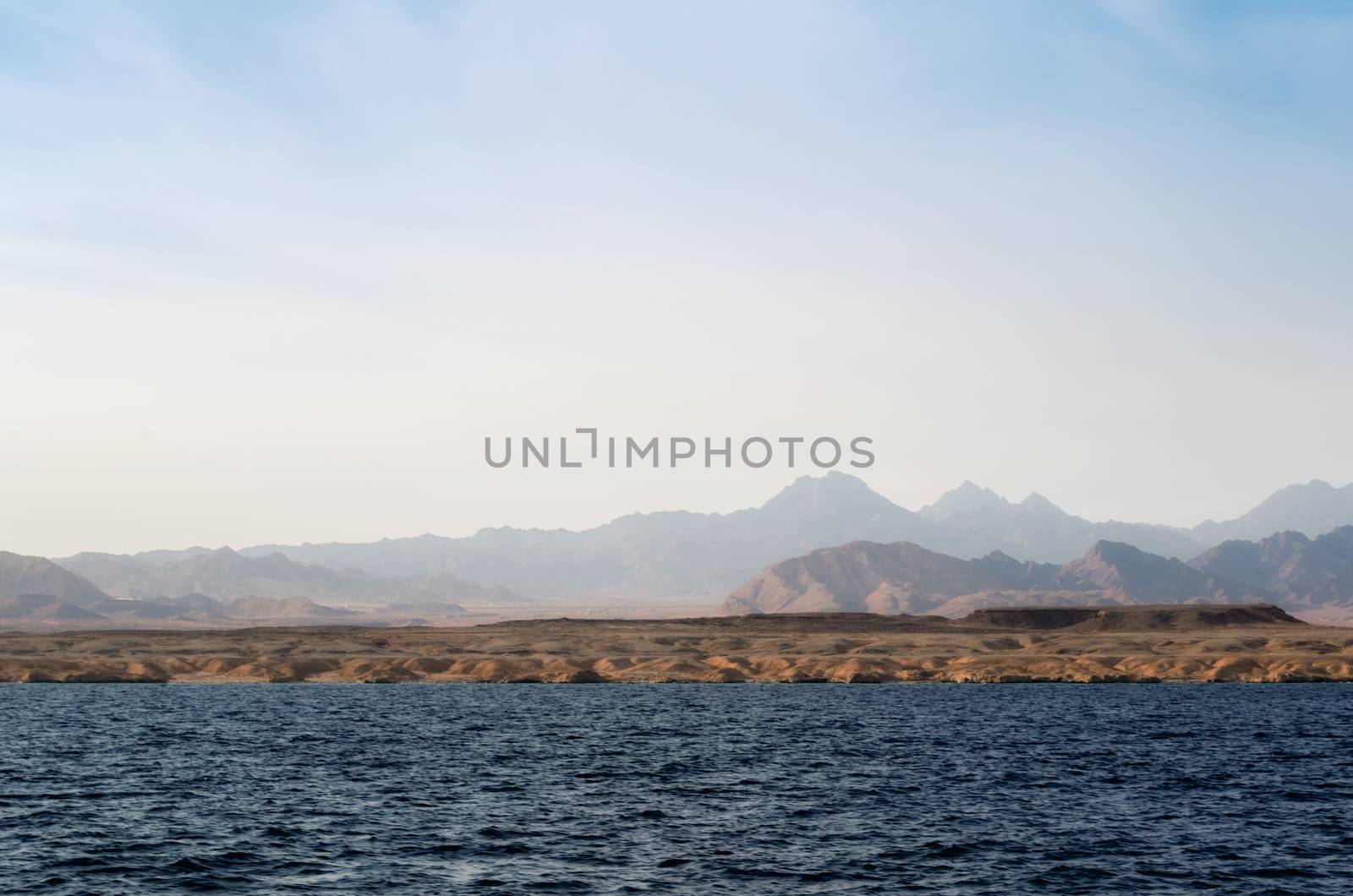 landscape rocky coast of the Red Sea and
blue sky with clouds in Sharm El Sheikh Egypt