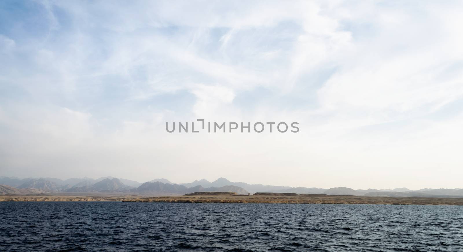 landscape rocky coast of the Red Sea and
blue sky with clouds in Sharm El Sheikh Egypt