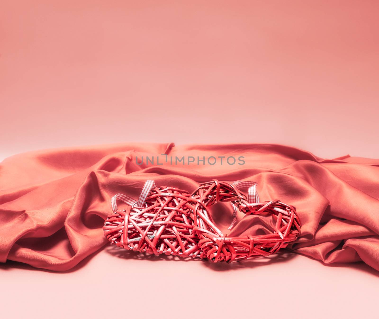 valentines day decor red heart on pink fabric love romantic background close up isolated