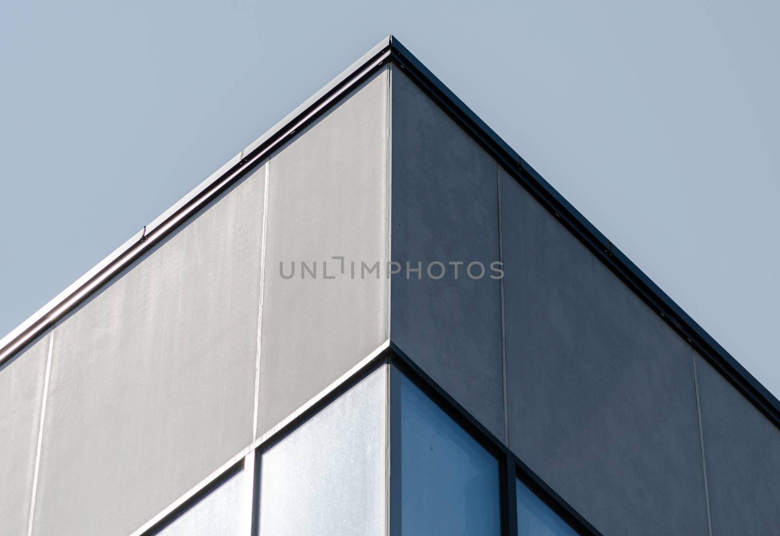 corner of a concrete building with windows