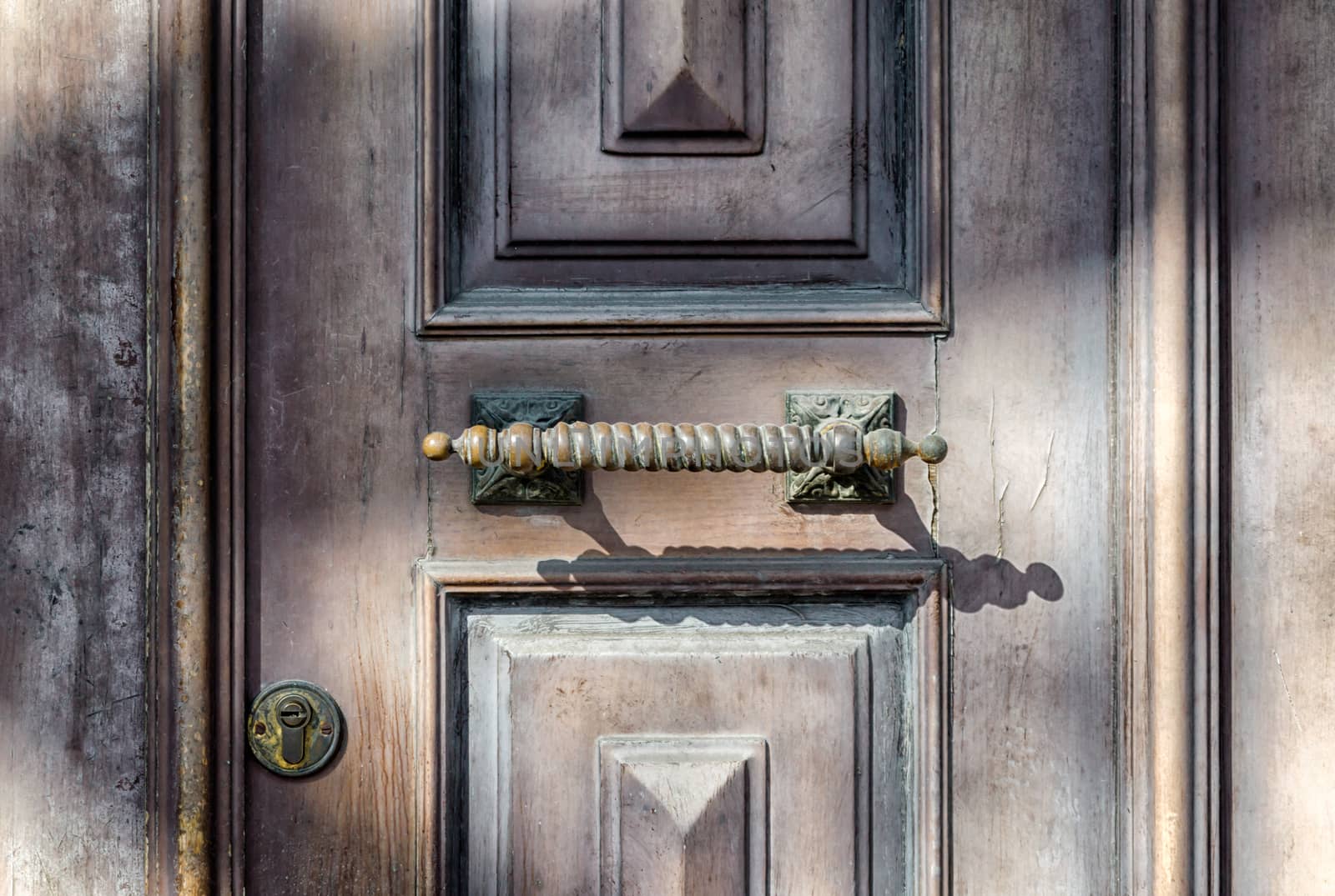 old wooden vintage door with handle and lock retro background close up