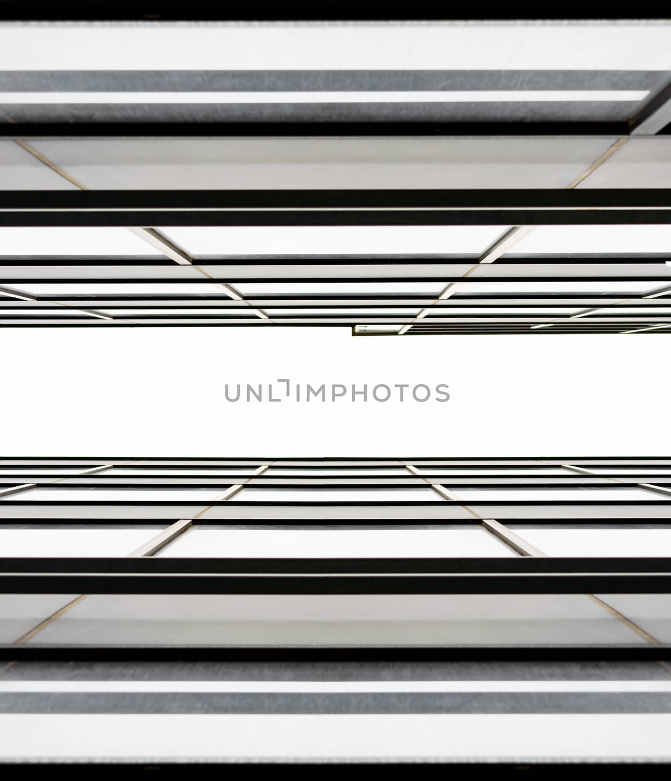 fragment of the wall and windows of a modern tall office building without people  abstract architectural monochromatic background