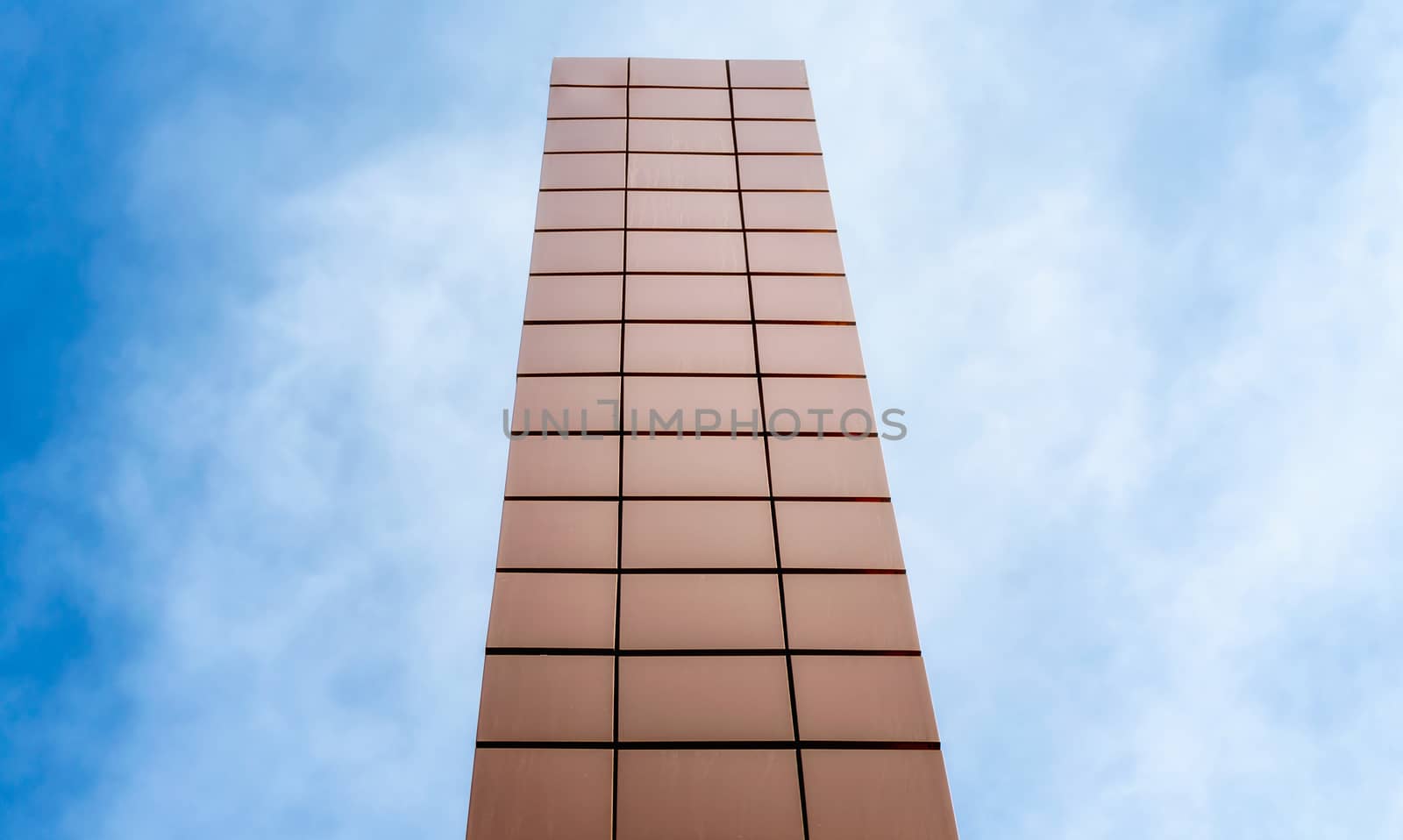 tall modern building tower against the blue sky and clouds architectural background