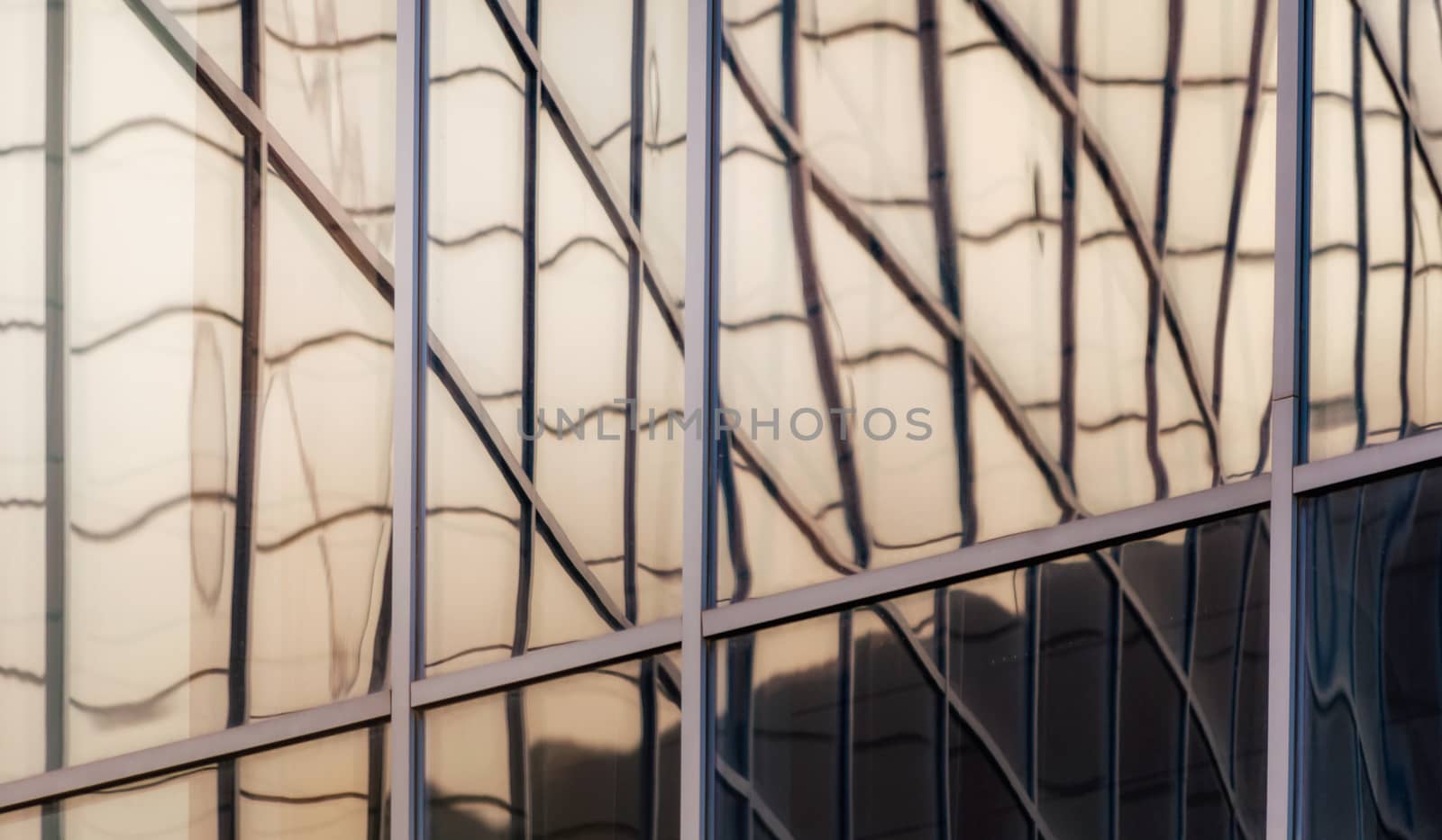 reflection with distortion in the window of a modern building color blue abstract urban background