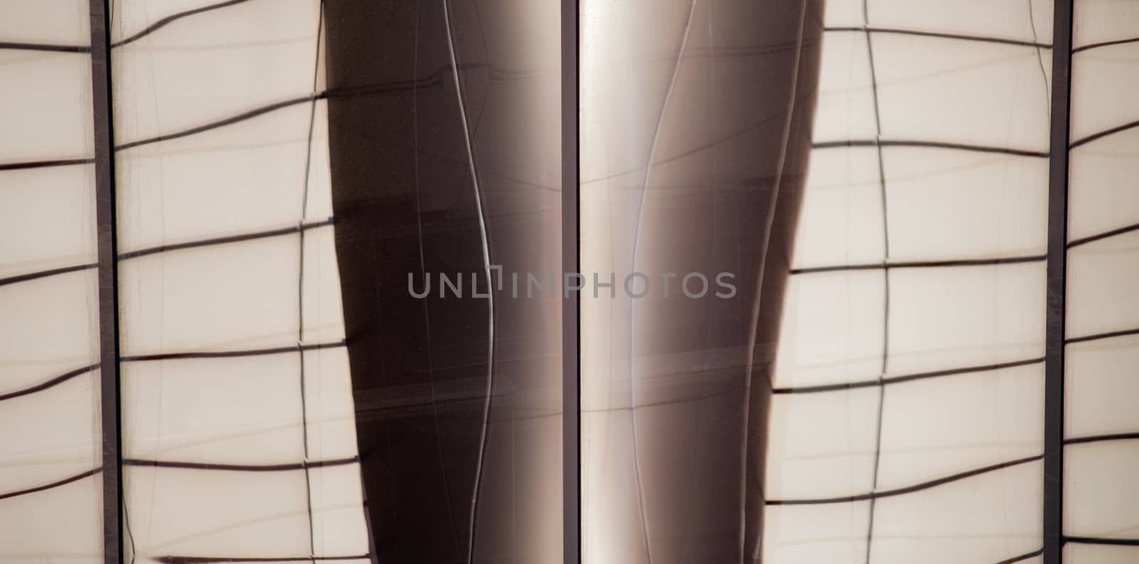 reflection with distortion in the window of a modern building color abstract urban background