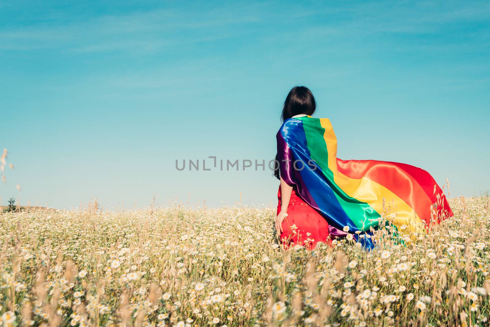 woman with lgbt flag on the field