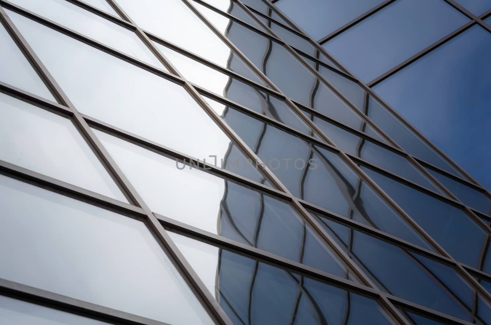 reflection with distortion in the window of a modern building color blue abstract urban background