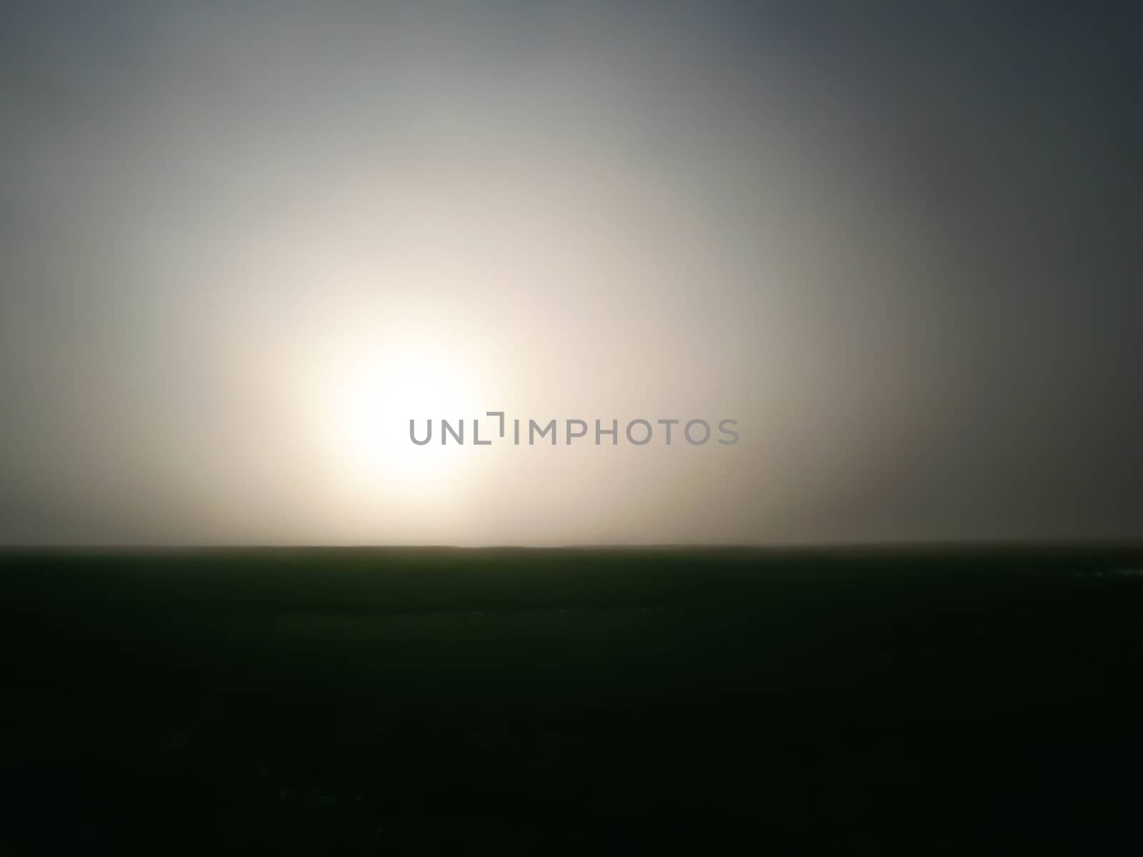 sunset in the evening over a field at dusk without people abstract gradient landscape background