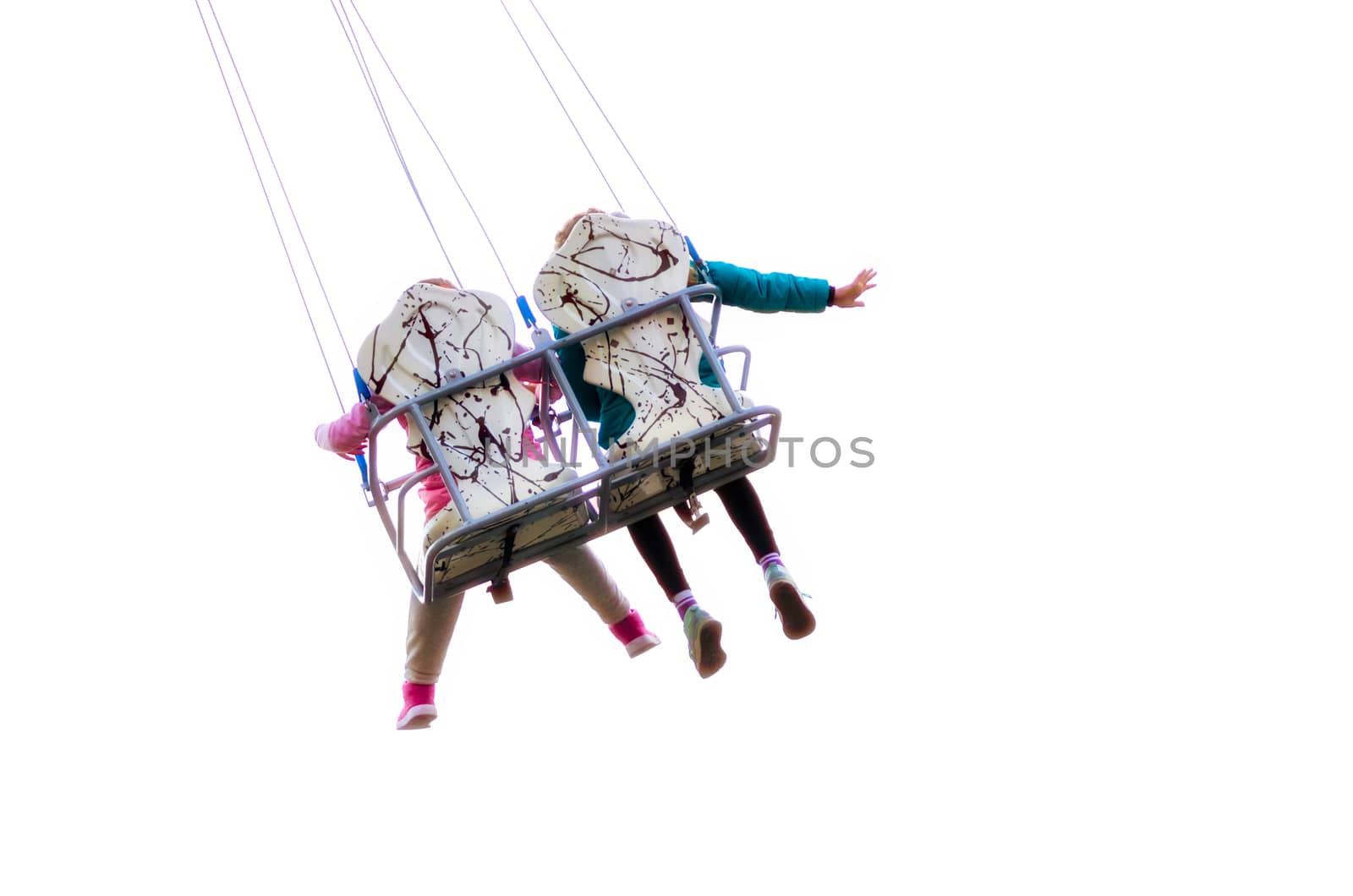 children ride on a carousel in an amusement park isolated on white background