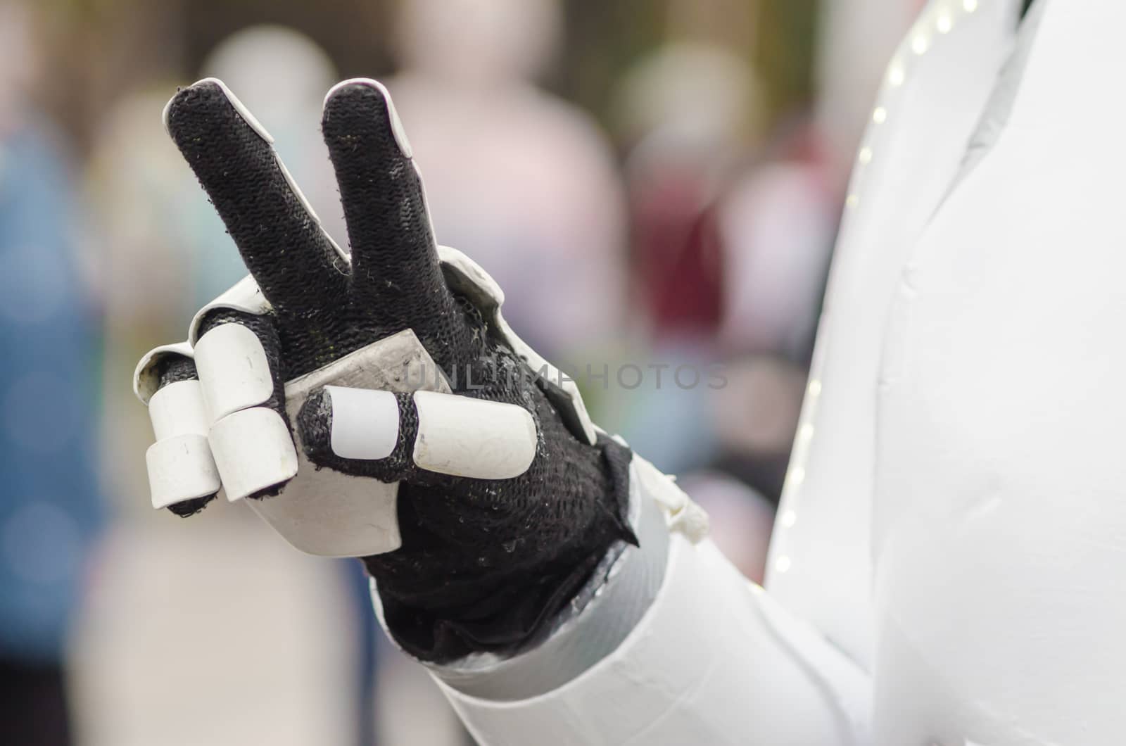 two finger gesture signifying victory or peace in a robot suit close up