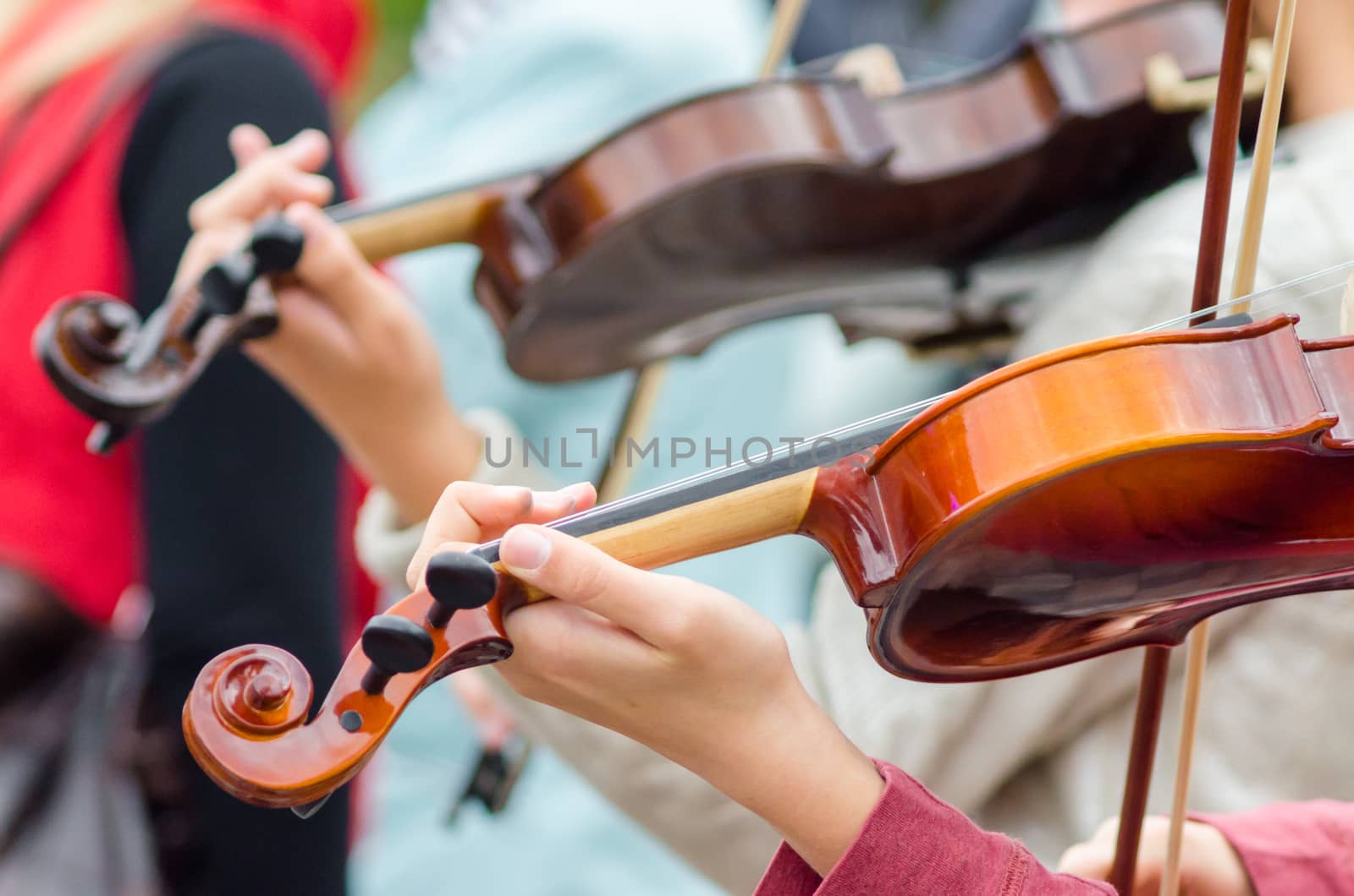 hands of a street musician girl with violin close up