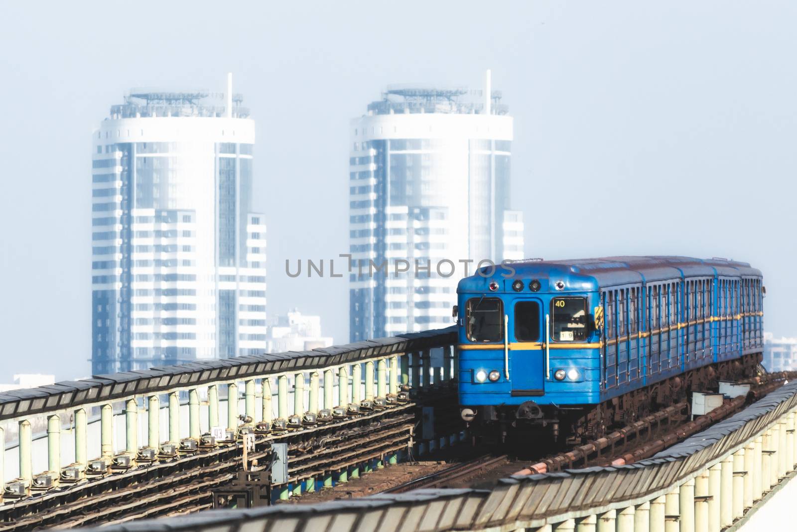 blue vintage metro cars on the background of office skyscrapers in Kiev Ukraine in the morning