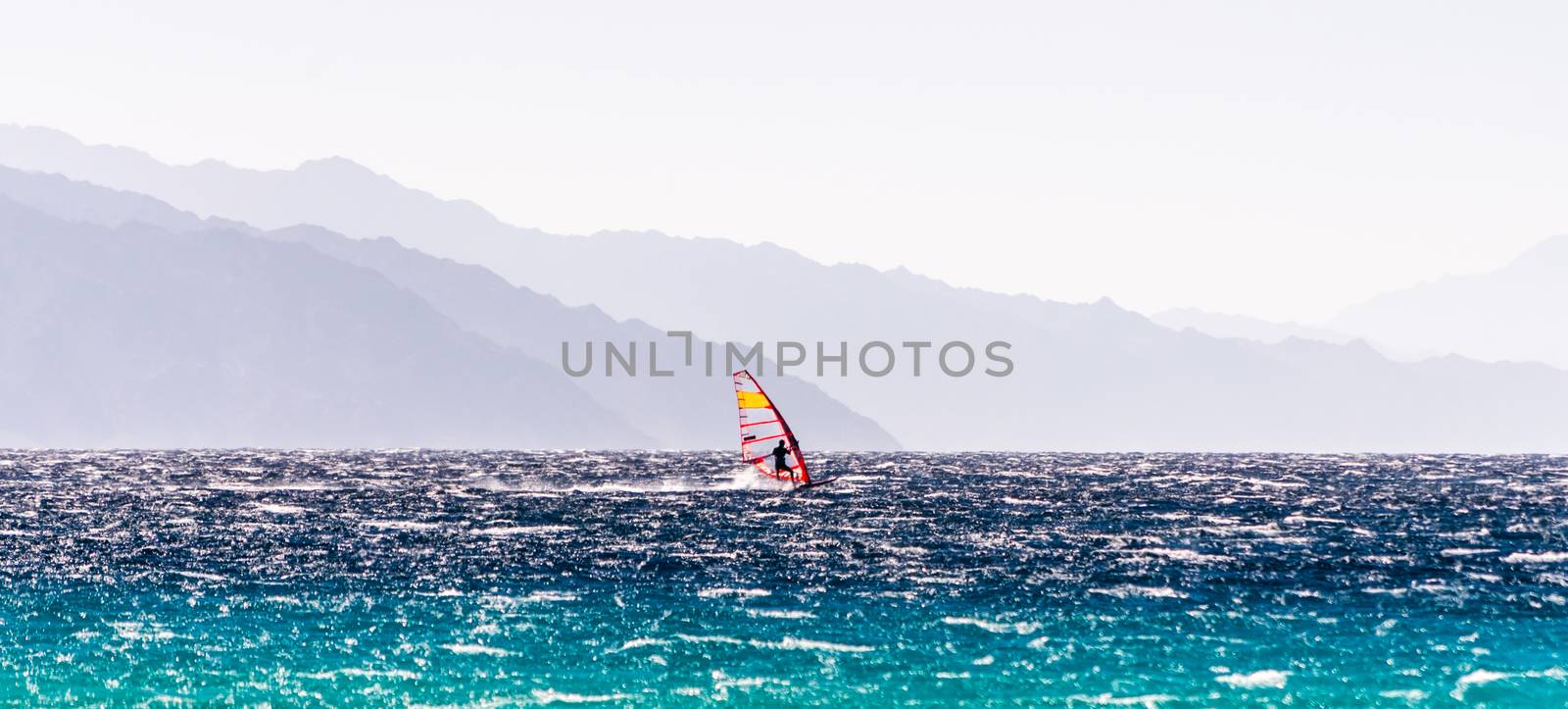 windsurfer rides on a background of high mountains in Egypt Dahab South Sinai