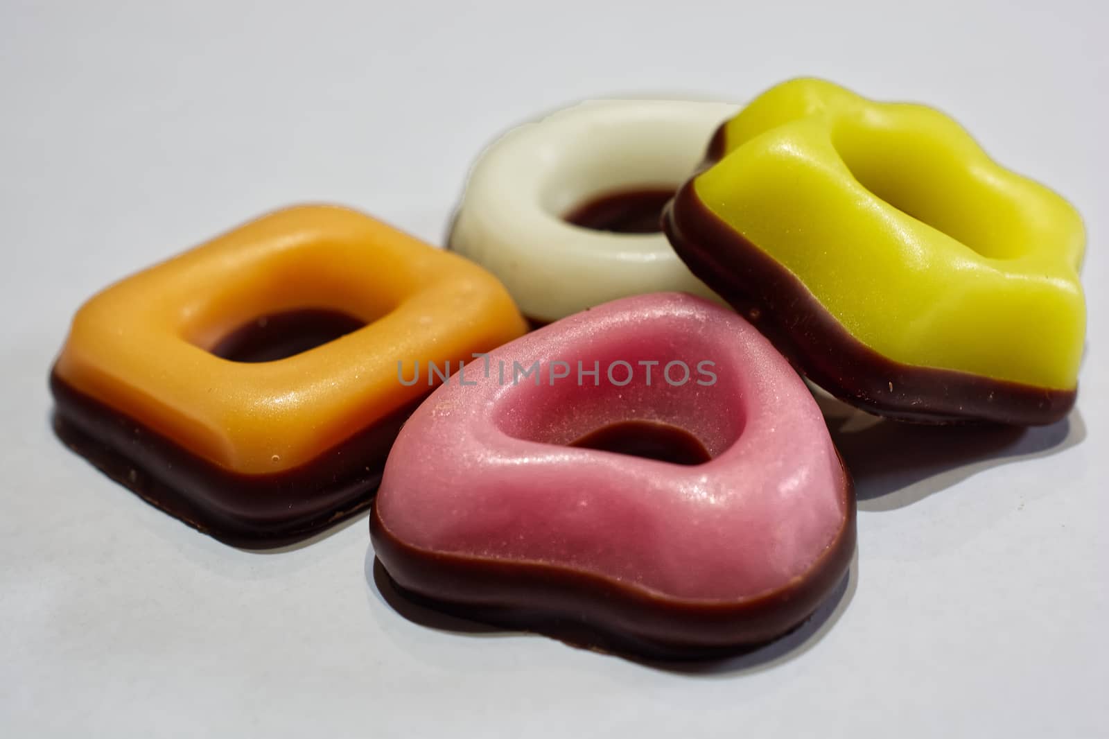 Assorted donuts in white, yellow, orange and pink colors