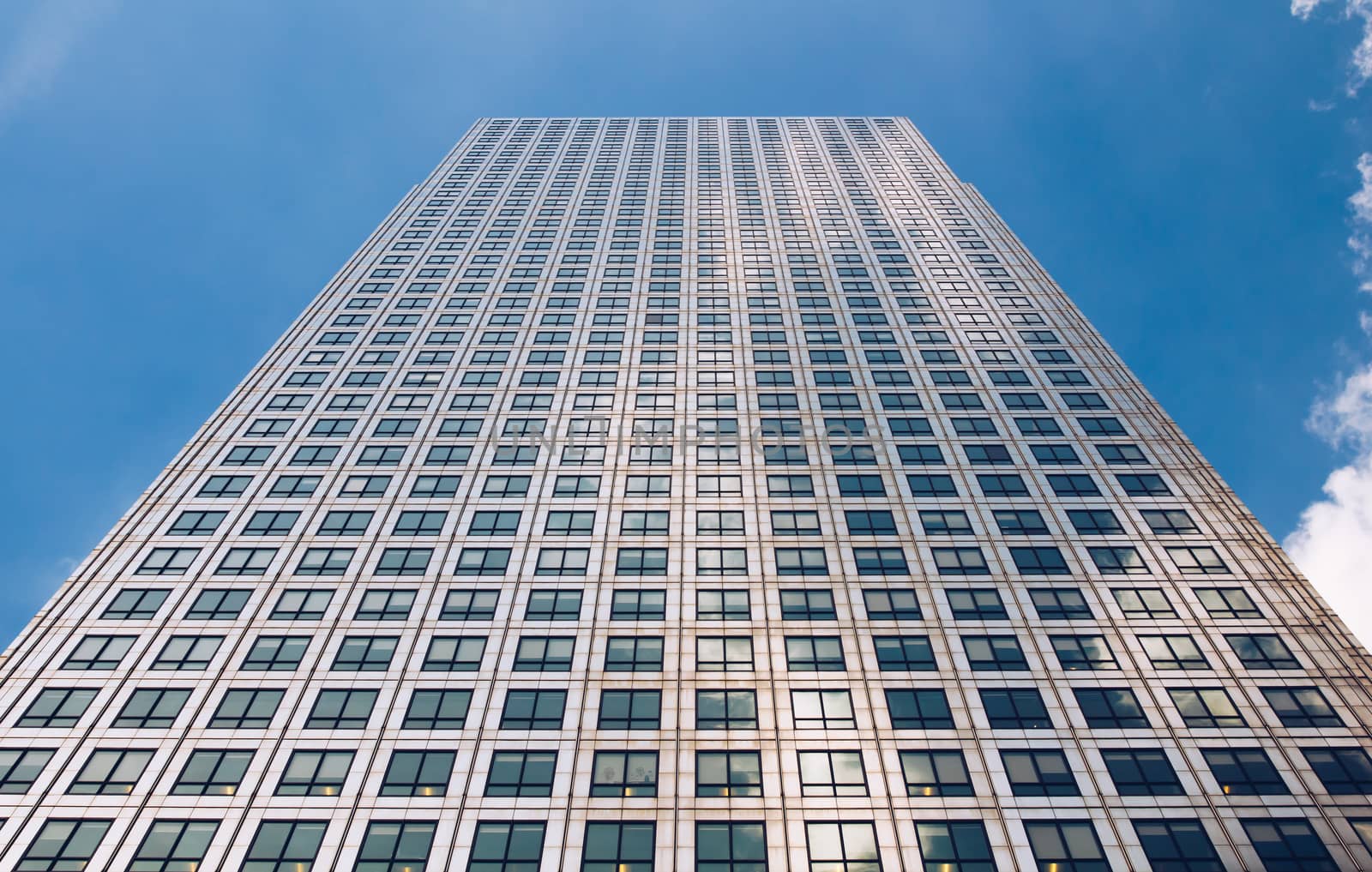 Modern glass exterior of corporate office buildings shot from a low angle.
