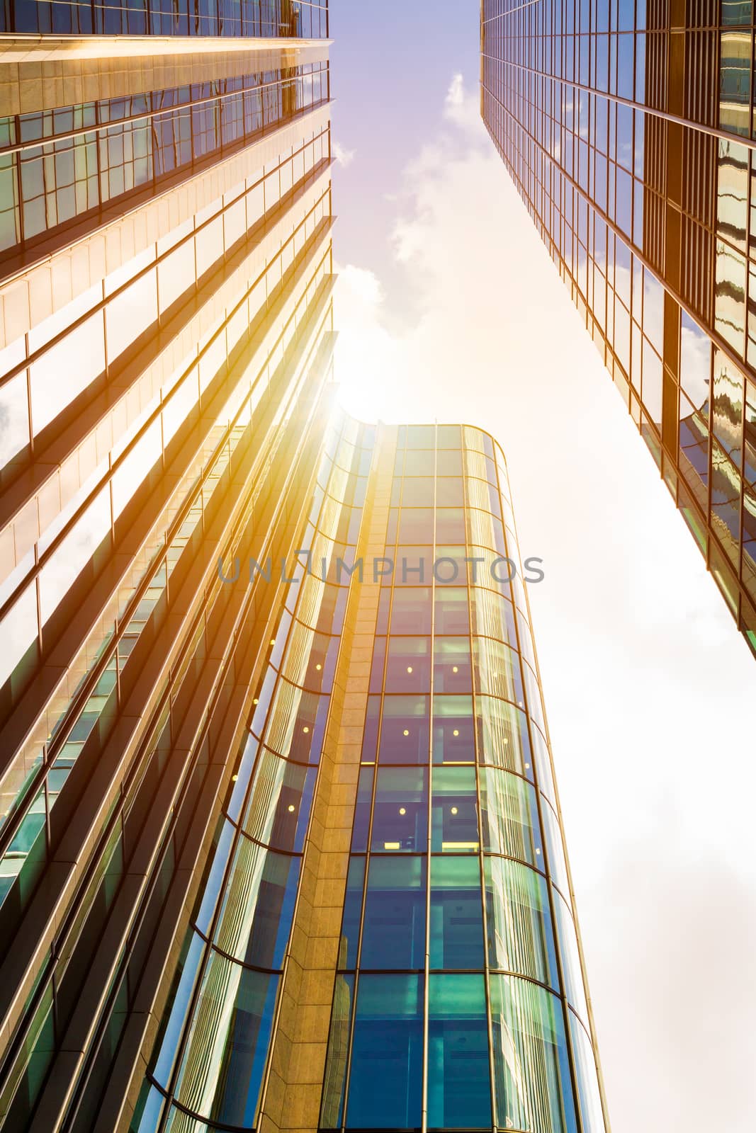 Modern glass exterior of corporate office buildings shot from a low angle.