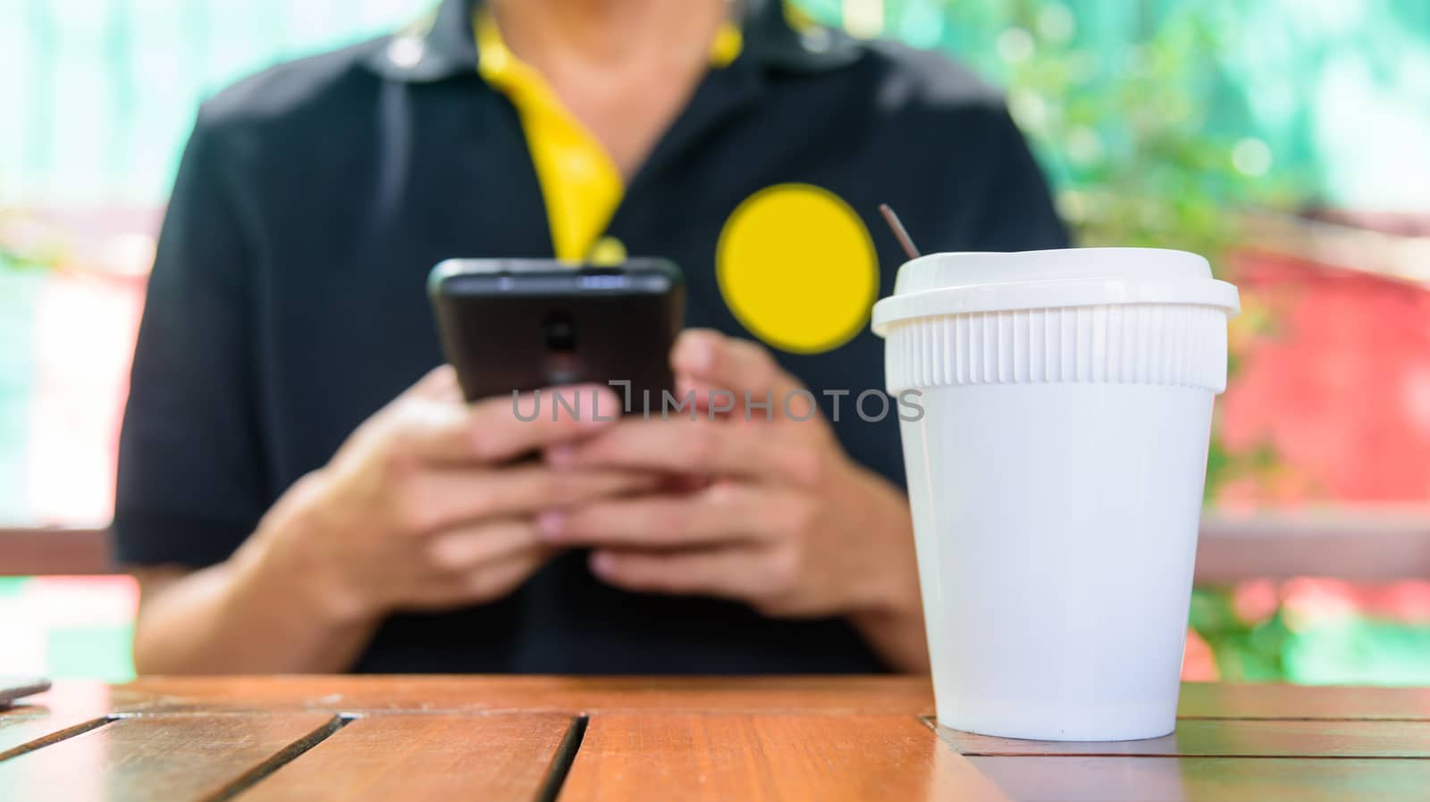 The man use smartphone in coffee shop by rukawajung