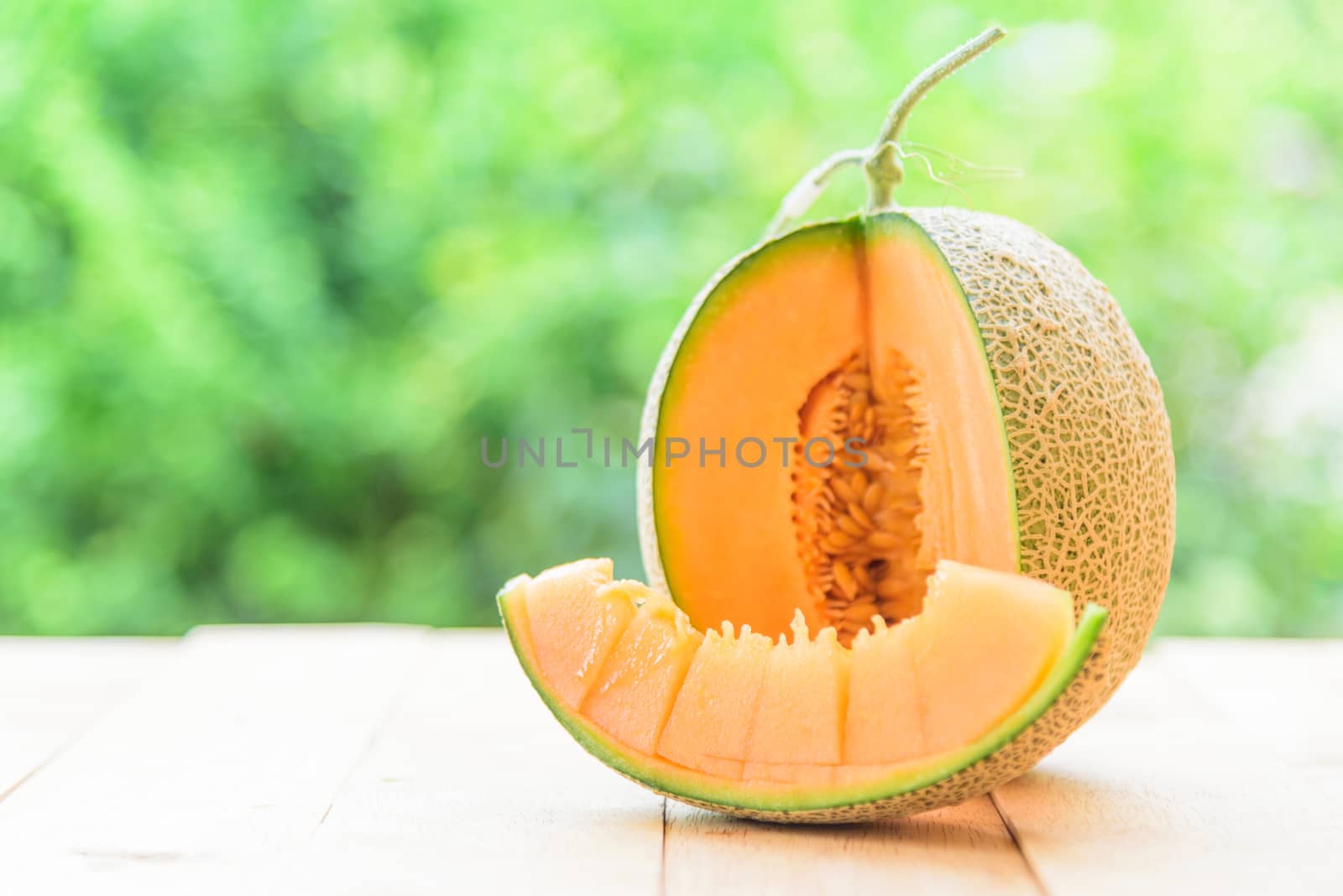 Fresh Orange melon on wood plate