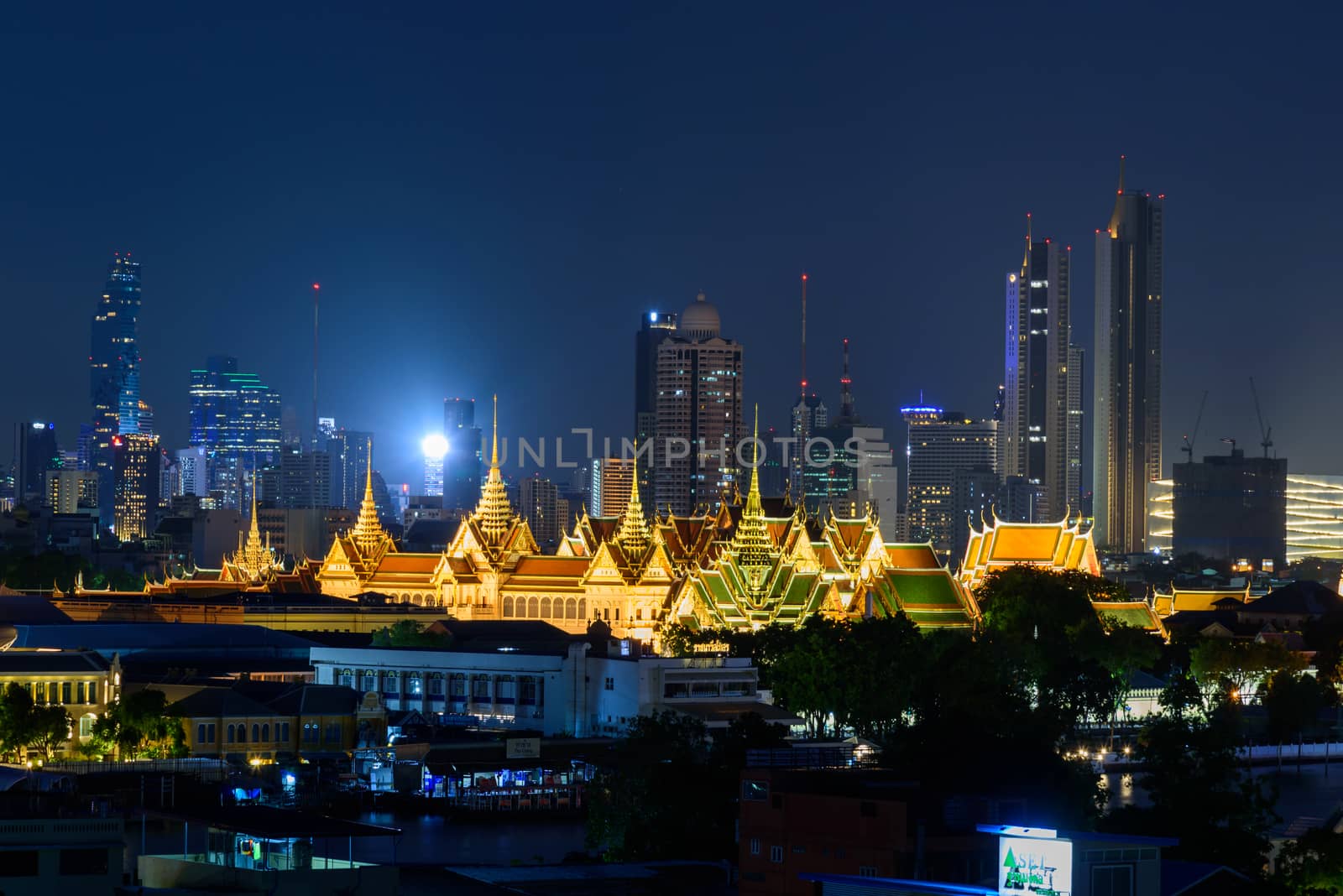 Bangkok , Thailand - 19 June, 2020: Wat Phra Keaw Public landmark of Thailand in night time and city in background