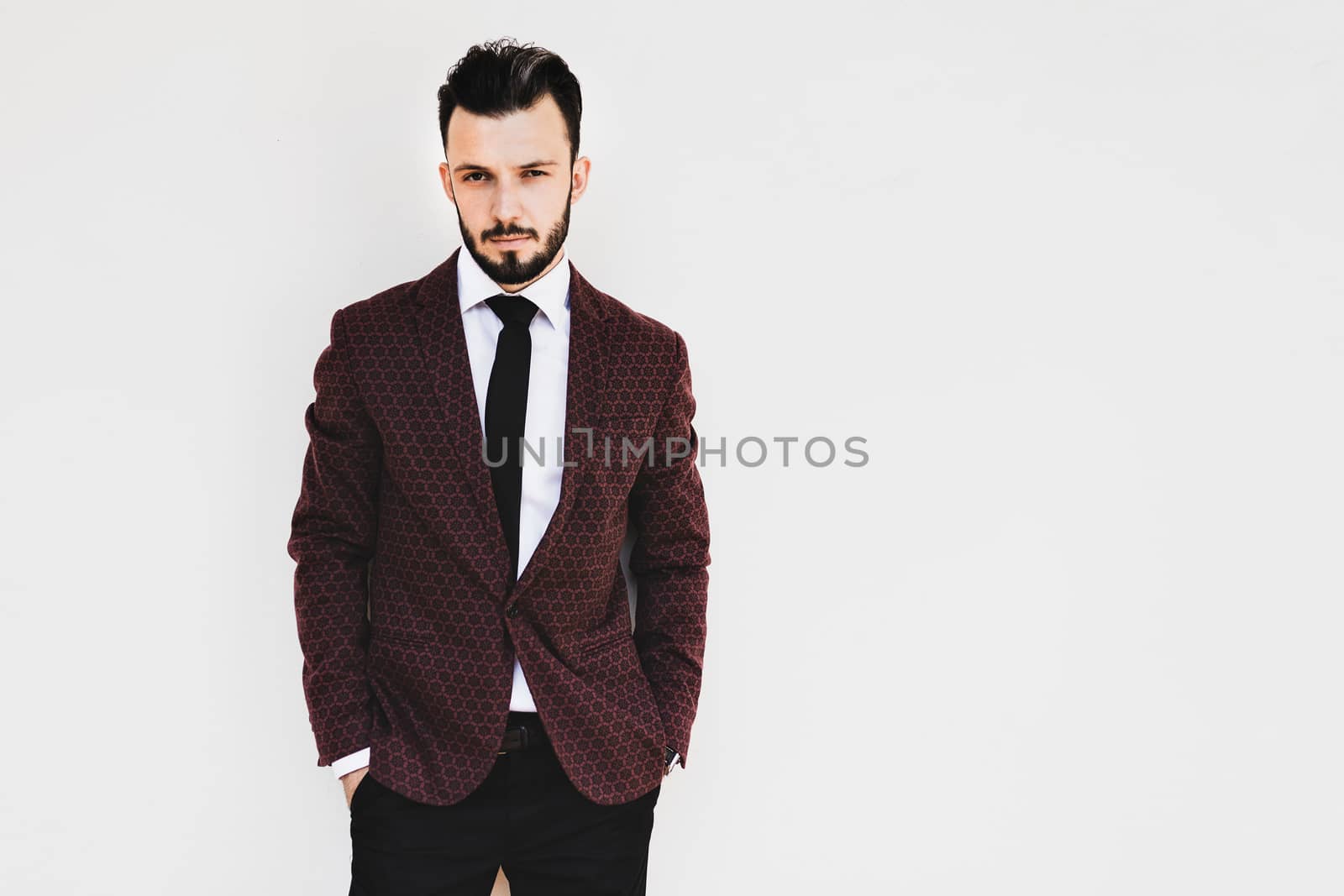 Handsome and elegant fashionable man or businessman posing a white background